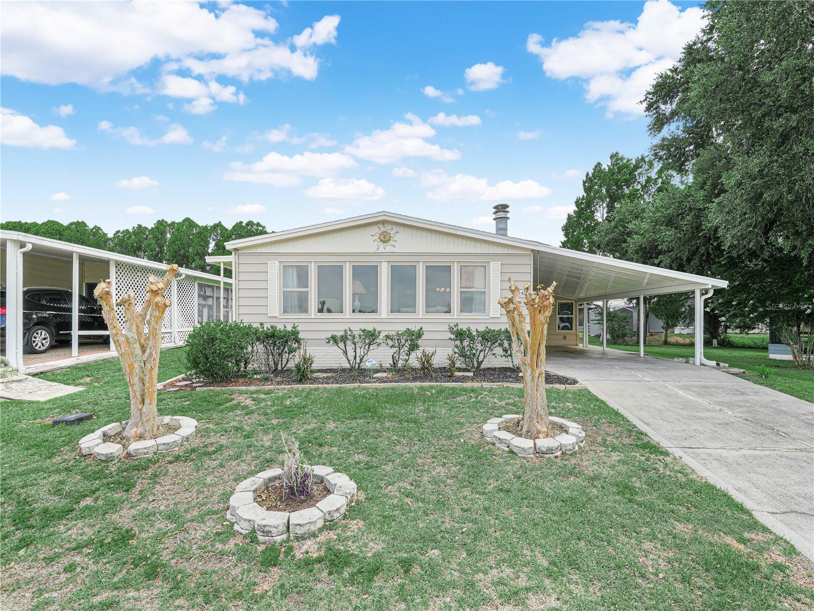 Retire to Florida living in this charming 2-bedroom, 2-bath home in Foxwood Lake Estates, a welcoming 55+ community. The family room is flooded with Florida sunshine from wall-to-wall windows overlooking the front yard and features a cozy wood-burning fireplace framed by built-in bookshelves—a perfect backdrop for entertaining or relaxing. The formal dining room includes a built-in china cabinet, while the kitchen offers a center island and all appliances included, plus a dinette area with a built-in bar for casual gatherings. Retreat to a tranquil main suite with an ensuite bathroom, walk-in shower, walk-in closet, and double sinks for a smooth morning routine. A second bedroom with its own bathroom and walk-in closet accommodates guests or hobbies. The interior laundry room provides extra storage, and the air-conditioned workshop invites your projects and additional storage needs. The HOA covers a community pool, recreation facilities, gated entry, and roaming security, delivering a carefree Florida lifestyle you can start enjoying right away. Schedule your private tour today.