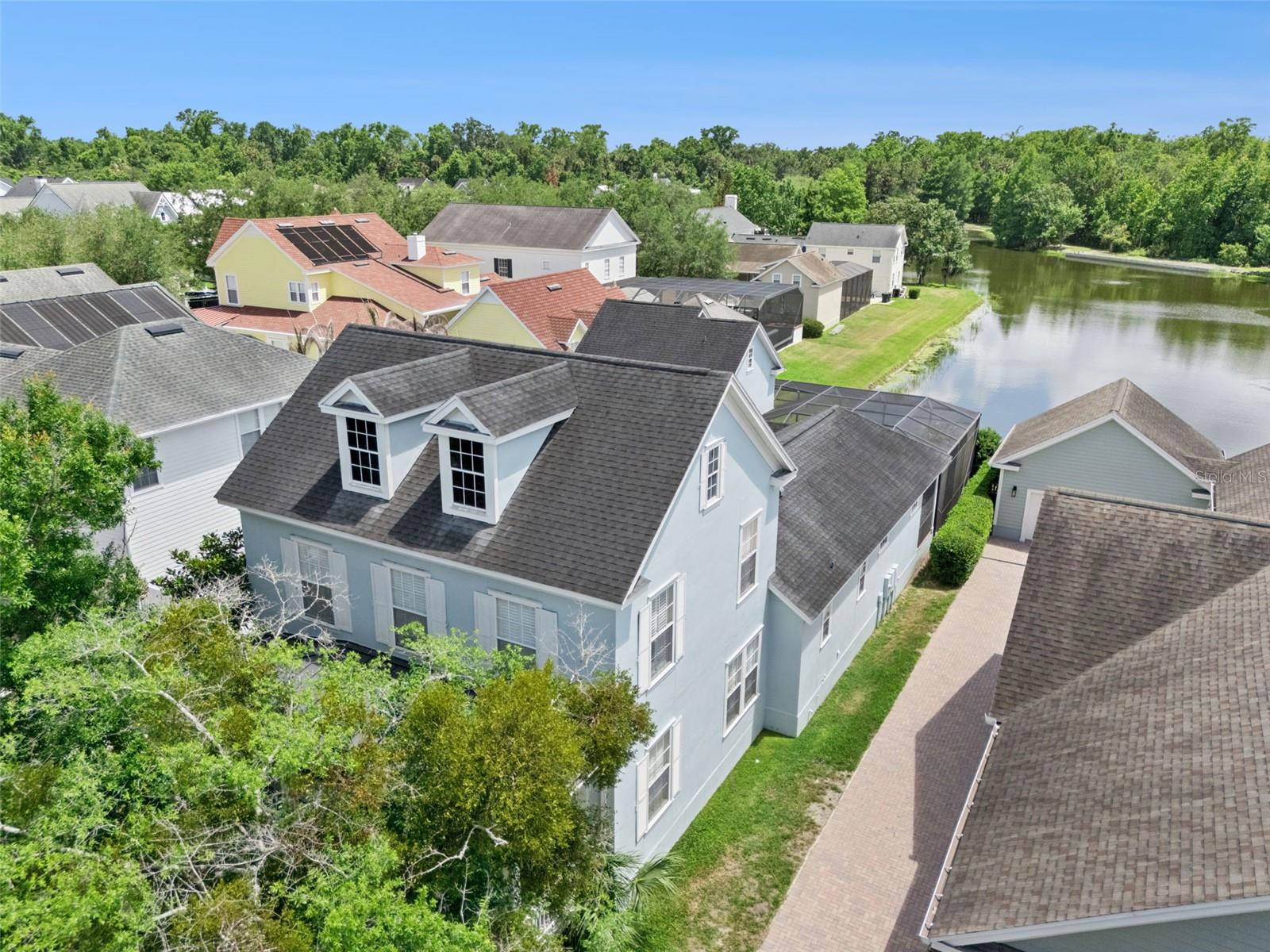 Located in beautiful South Village, this stunning fully furnished 5-bedroom, 4.5-bath pool home offers tranquil pond and water views, a long driveway with ample parking, and an exceptional layout designed for both everyday living and entertaining. Light, bright, and beautifully open, the home welcomes you with elegant formal living and dining spaces featuring hardwood floors, crown molding, and plantation shutters. At the heart of the home is the comfortable living area filled with natural light and showcasing beautiful views of the pool, pond, and conservation beyond. The spacious kitchen opens seamlessly to this inviting space, creating the perfect setting for gathering and entertaining. The generously sized downstairs primary suite provides privacy and convenience, while upstairs you will find three additional bedrooms, two full baths, and a wonderful retreat area. Step outside to your private outdoor oasis featuring a screened patio with pool and spa, brick pavers, a large covered pavered lanai with ample seating space, and breathtaking tranquil water views. This one-of-a-kind lake lot truly captures the best of Celebration living and is perfect for entertaining. Adding even more flexibility, the studio garage apartment is ideal for guests, a home office, or rental income opportunity. Beautifully maintained and thoughtfully upgraded throughout, this exceptional South Village home is being offered fully furnished, making it truly move-in ready. Additional updates include a new roof in 2017 and replacement of the main home AC in 2024. Celebration offers miles of walking and biking trails, community pools, parks, playgrounds, dog parks, golf, tennis, seasonal events, farmers markets, and a vibrant downtown filled with boutique shopping and dining. Ideally located just minutes from Walt Disney World, major attractions, shopping, and Orlando International Airport. Call to schedule your private showing today.
