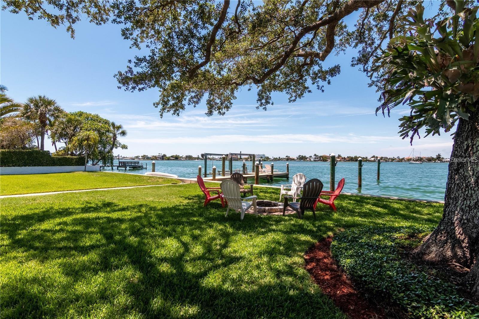 Prime oversized lot on Paradise Lane, Treasure Island, within walking distance to the beach, shopping, and dining. The street is adorned with large new homes. with additional ones under construction. The lot features a 6,902 sq ft rebuildable structure, or it can be cleared for you to construct your dream home. It is not located on a canal but offers open water bay and intracoastal views, with calm waters off the deep dock.