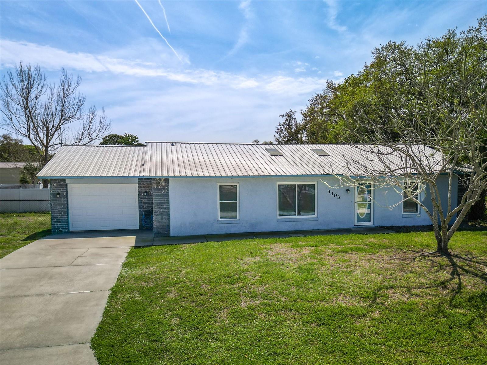 3-bedroom, 2-bath home featuring a desirable open floor plan and split-bedroom layout for added privacy. The updated kitchen boasts modern finishes, stainless steel appliances, and ample cabinet space, perfect for both everyday living and entertaining. Enjoy additional living space in the bright Florida room, ideal for relaxing or hosting guests.

This home also includes an inside laundry room for convenience, a 1-car garage with a separate storage room, and a Galvalume metal roof life expectancy 30-50 yrs and main windows updated to Impact for long-term peace of mind. The fully fenced yard offers privacy and plenty of space for outdoor activities, pets, or gardening.  Water heater 2018, AC 2004, roof 20 yrs old-pls read remarks