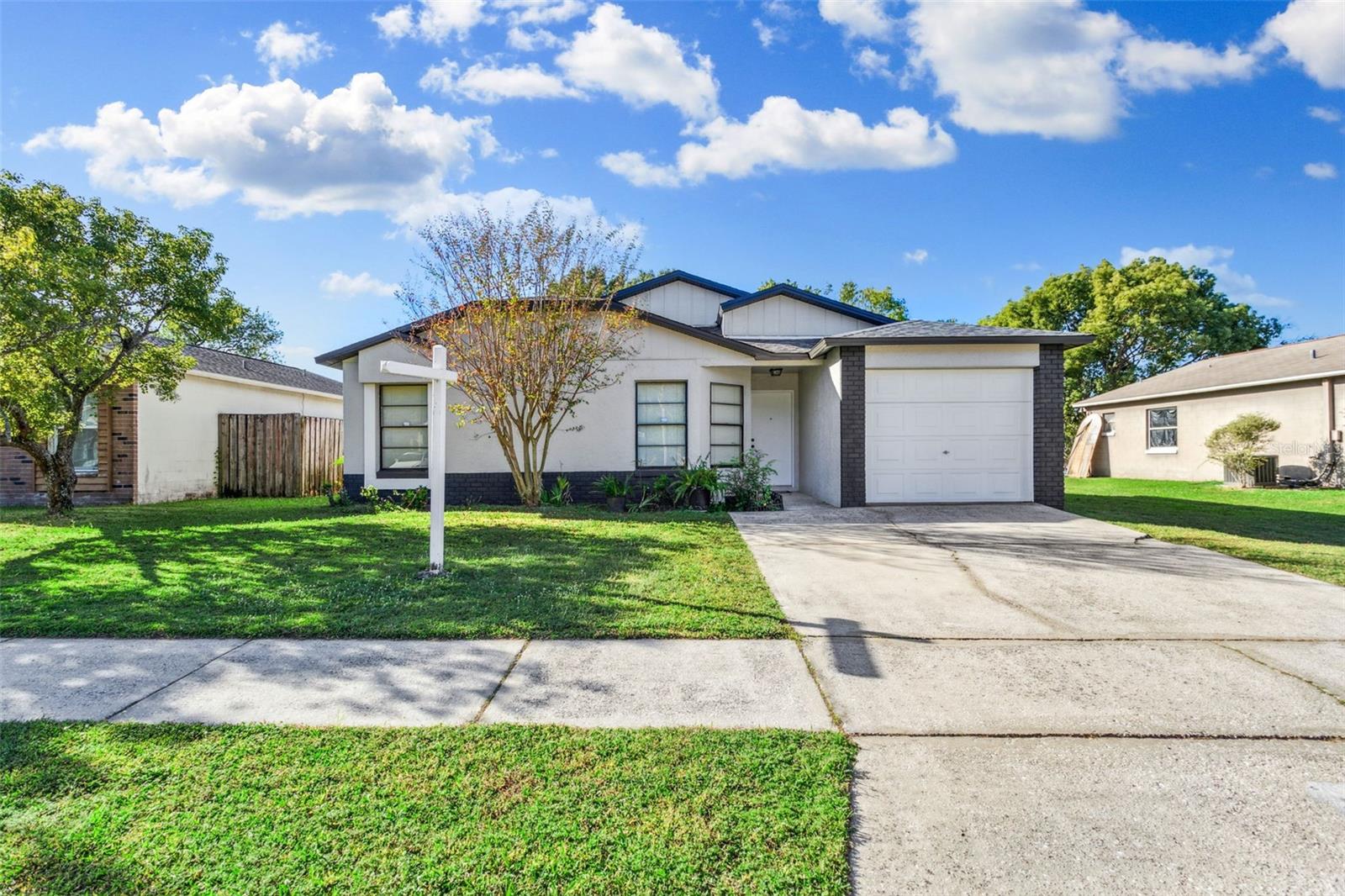 There are very few 3/2 block homes at this price on the market these days. Nice size secondary bedrooms. Master bedroom with ensuite and 2 closets, 1 of them is a walk in closet!  No backyard neighbors!  This property has a bonus with water frontage in the back yard that provides a beautiful, relaxing water view from your screen porch to unwind in the evenings or enjoy that morning cup of coffee. You also have a water view from the eat in dining space in kitchen! There's a  brand new roof and new AC compressor both 2023. Hot water heater 2021. New water proof laminate has just been installed throughout the entire home! That means most of the big ticket items have been taken care of for you. The exterior of the home has just been painted too! Another plus is vaulted ceilings in the kitchen and living room to make it feel more spacious and airy. There's also a lot of natural light coming through! This home is move in ready. You can update or add your own personal touches whenever you want to. There are 2 matching sheds with electric for storage or workshop in the backyard. The sheds are in good shape and already have shelves for your convenience. This community has low HOA dues too! Great location, just take I-4 to get to the Tampa International Airport which is 20 miles away.  Minutes from Tampa and all that has to offer with restaurants, sports and entertainment.  Brandon also has so many shops and restaurants to enjoy.  Beaches are under an hour away! Call today and make this home yours!