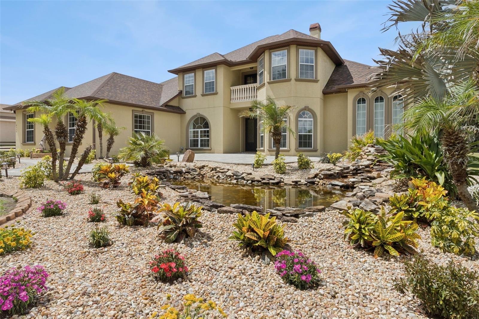 Welcome to your private retreat—an exceptional custom home offering just under 4,000 square feet of beautifully designed living space on more than an acre of lush, landscaped property. From the moment you arrive, the stunning curb appeal sets the tone with a tranquil waterfall and pond feature that could easily become your own koi sanctuary. With NO HOA and more than an acre…the possibilities are endless! 

Inside, sophistication and comfort blend seamlessly throughout. The chef’s kitchen is a true showpiece featuring premium Electrolux ICON appliances, solid concrete countertops with custom formed sinks, a walk-in pantry, breakfast nook, and abundant space for entertaining and everyday living. Soaring cathedral ceilings create an airy, open feel while thoughtfully designed details throughout the home add both elegance and functionality while multiple downstairs spaces are complimented with custom-designed sandblasted glass French doors, and both living- and family rooms boast gas fireplaces as show-stopping centerpieces. 

The luxurious primary suite offers a spa-inspired en suite bath complete with a relaxing garden tub, Roman shower, and expansive walk-in closets. Every bedroom features its own walk-in closet, and an additional upstairs en suite provides ideal accommodations for guests or multigenerational living. Enjoy peaceful mornings or evening sunsets from the private terrace balcony overlooking the picturesque grounds.

Additional highlights include a spacious 3-car garage, convenient laundry chute, oversized 12’x30’ powered shed, designer bathrooms, and countless custom touches throughout. With space, style, and standout features both inside and out, this extraordinary property delivers the perfect balance of luxury living and private serenity, all right in the heart of central Florida just minutes from an abundance of convenient grocery, dining, and shopping options. Even better, this extremely commutable location is also near to Lakeland and the Tampa/Brandon communities with the ability to reach Orlando and central Florida beaches in under an hour's time. This home is truly a work of art and a must-see--schedule your private showing TODAY!