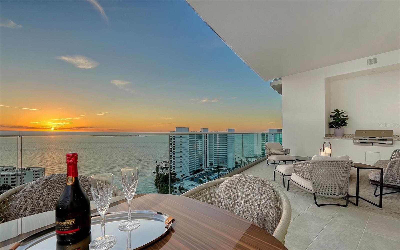 This fully bespoke designer corner residence at the Ritz-Carlton Residences Sarasota offers enduring, world-class luxury for buyers accustomed to the best. A clean, modern interior hand-finished by local artisans, panoramic bay-to-Gulf views, fully integrated home automation and legendary Ritz service sets the highest standard for an urban resort lifestyle. In downtown Sarasota’s flourishing Quay District, life here is centered on ease and access. It’s an easy distance to The Bay, Bayfront Park and Marina Jack. Downtown restaurants, boutiques, galleries, groceries, cinemas and farmers market are within a mile, while SRQ International Airport, Sarasota Memorial Hospital, St. Armands Circle and Lido Beach are all within three miles. A flow-through layout is framed by floor-to-ceiling glass and luminous vistas. Wake up each day to this amazing view when the shades automatically go up at the appointed time. Three balconies extend the sunny disposition, highlighted by a 31-by-12-foot main terrace with a built-in electric grill. Distinctive details include a built-in lounge bench with automated pop-up table, an elegant wet bar with leather-clad cabinetry, custom textured metal accent walls, Aku wood-slat acoustic panels and genuine crushed-pearl textured paint. A standout feature of this three-bedroom, three-and-a-half-bath residence is the expansive primary bath. Wrapped in marble stone, it features dual vanities, a micro-jetted soaking tub and a double shower with ceiling rain showers, adjustable sprays and in-wall body sprays. Dual walk-in closets are equally considered, with integrated lighting and custom wardrobe organizers designed to keep everything neatly within reach. Amenities reflect the Ritz-Carlton gold standard of care, led by 24-hour dedicated staff and concierge service, along with room service from Jack Dusty's. On-site property management, waterfront pool, lap pool, fitness room, game room and gathering spaces complete the lifestyle. This is The Ritz-Carlton at its most personal, bespoke, beautifully finished and fully integrated, with clear bay-to-Gulf views and three-balcony outdoor living. For buyers accustomed to the best, it’s a rare chance to claim a signature residence in downtown Sarasota’s Quay District.
