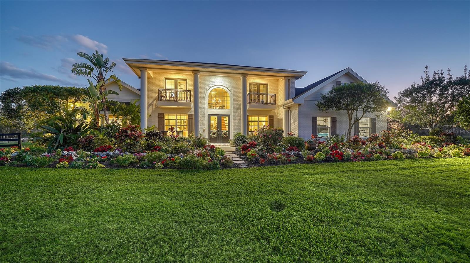 Love the home you wake up in every morning, and this is the one for you.  Peace and tranquility await you here.  Each day as you begin and end your day you are reminded to take a moment, breathe, and take in the beauty of nature and the softness it offers us.  A new day begins just inside your beautiful gated estate of 5.3 meticulously maintained high and dry acres where memories are made and remembered and this property has the potential to be an amazing multigenerational property as well.  This stunning 2 story home and lush property is the perfect mix of luxurious comfort and relaxation.  The property is cleared, with mature oak trees, amazing gardens, a 20’ x 40’ pool with a 10’ x 12’ sun shelf perfect for sunbathing and is connected a large pool cabana with fans that is the original home on the property and has a ¼ size basketball court connected and an oversized firepit area nestled near the activity perfect for cool night an cookouts. This amazing property includes 2 barns, 1 with 4 oversized stalls, a tack room and office and the second with 3 – 4 stalls both barns include water feeds.  This is the perfect home to unwind and entertain friends and family with over 3400 square feet of living space and plenty of outdoor amenities too keep everyone entertained. Once you enter the home you are greeted by a spacious foyer with 2 story ceilings that connect to the Living Room and features a wet bar and separate Dining Room divided by the home’s wood staircase leading to the 2nd floor.  Wood floors and large windows throughout the home boosting unrestricted natural light can’t help but brighten and illuminate each room. At the heart of the home lies a spacious family room with a cozy wood burning fireplace, 2 story ceilings and French doors leading out to a screened lanai overlooking the resort like backyard, pool, cabana, barns and back pasture.  The well-designed kitchen has double ovens, two dishwashers, granite countertops and lots of prep space as well as connecting to a large eating area and a walk-in pantry that every home needs.  The Master Suite invites you to relax and unwind and greets you each morning with the most glorious sunrises.  The newly renovated Master Bathroom is a peaceful retreat on its own with an oversize soaking tub, marble floors and shower and double vanities overlooking a glorious garden.  Upstairs are two generous sized guest bedrooms each featuring a balcony overlooking the beautiful green front pasture, en-suite bathroom, and spacious walk-in closets.  The first floor offers a Powder bath as well as a second half bath that leads out to the pool and outdoor shower area.  A second A/C unit was installed in 2023, new roof in 2020 and in 2023 a Generac generator with a 1000 gallon propane tank that will run the entire house and barn for 13 days should power go out was installed. This home begs you to unwind and have some outdoor fun, relax and laugh in and recharge and it’s just minutes from Twin Lakes Park, I-75 and only 20 minutes to the famous Siesta Key Beach.  You will not find many exceptional properties like this with the acreage, amenities and proximity to shopping, restaurants, and activities in Sarasota. It truly is the definition of tranquility and convenience! Room Feature: Linen Closet In Bath (Primary Bathroom).