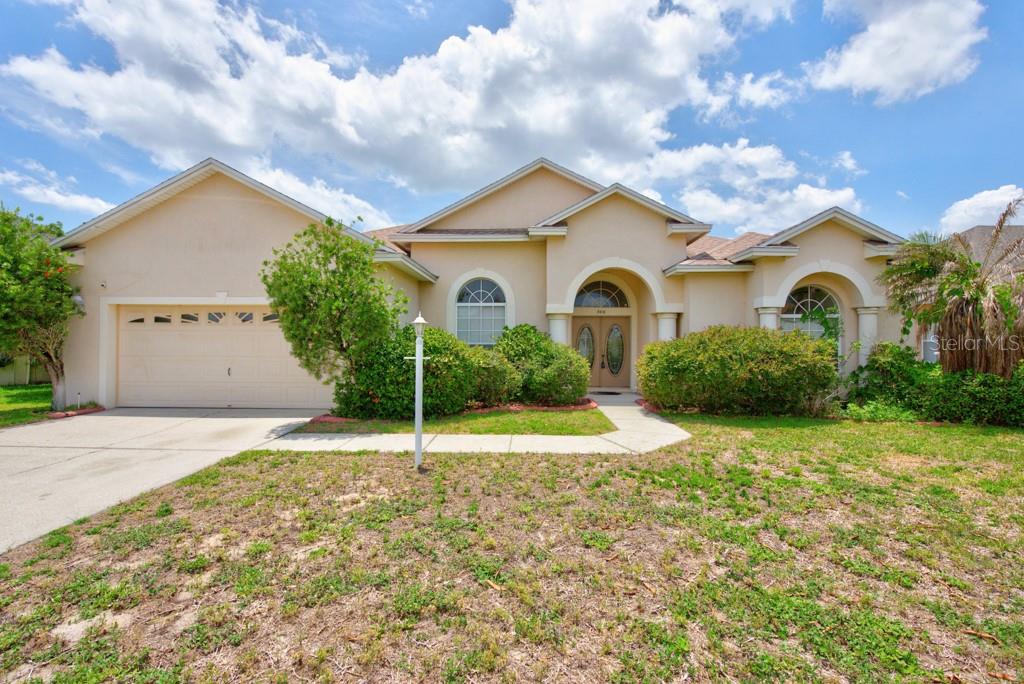 Set on a spacious .24-acre homesite in the gated Terranova community, this beautifully designed 4-bedroom, 3-bathroom home offers over 2,400 square feet of comfortable living space with a layout that perfectly balances openness and privacy. Mature fruit trees, a low HOA, and no CDD fees make this an exceptional opportunity in one of Winter Haven’s most desirable neighborhoods. Inside, you'll find an inviting open-concept design filled with natural light, enhanced by tile flooring throughout the main living areas and plush carpet in the bedrooms. The split-bedroom floor plan provides added privacy, making it ideal for families, guests, or multi-generational living. Spacious gathering areas flow seamlessly into a separate dining space featuring custom built-in shelving and a convenient sliding glass door leading to the backyard. The heart of the home is the generously sized kitchen, complete with a breakfast bar, abundant cabinet storage, and plenty of workspace for cooking and entertaining. Just beyond, the screened patio offers the perfect place to enjoy Florida’s year-round sunshine while overlooking the expansive backyard. Retreat to the oversized primary suite, where wide windows bring in beautiful natural light. The suite also features a large walk-in closet and a private ensuite bath with a soaking tub, separate shower, and dual functionality designed for everyday comfort. Additional highlights include a 2-car garage, three full bathrooms, ample storage throughout, and a thoughtfully designed single-story floor plan that maximizes both space and convenience. Located just minutes from LEGOLAND Florida Resort, shopping, dining, major roadways, and Winter Haven’s renowned Chain of Lakes, this home combines the tranquility of a gated community with easy access to everything Central Florida has to offer. Call now and schedule your viewing today because space, functionality, and location come together beautifully in this Terranova gem. ***FREE 1/0 Rate Buydown when using the seller's preferred lender!***