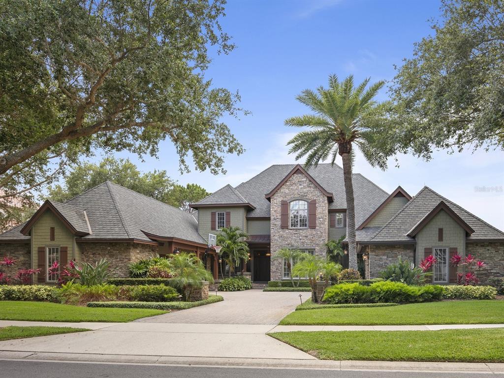Fabulous casually elegant French country estate in Keene's Pointe. Situated on the 18th fairway of The Golden Bear Club. This six bedroom, five bath home has unmatched custom detailing inside and out. This is truly a must see home to understand the quality of finish throughout. The grand two story entry drives your attention through a wall of rear glass with expansive golf views. The formal dining and sitting area flank each side of the entry. The massive two story family room opens perfectly to the kitchen fully equipped with top of the line appliances, custom cabinets and an informal dining area. There is a private screened in veranda off the kitchen area with tongue and groove ceiling, custom wood details and lighting – perfect for outdoor dining. Distressed hand-scraped hardwood floors, a wood and iron staircase with a balcony overlooking the family room, and a two-sided stone fireplace complete the gathering areas. The home office is incredibly finished with custom cabinetry, wall paneling, stone fireplace and golf views. The primary suite is spacious and offers a vaulted ceiling with tongue-and-groove pine. Upstairs you will find three additional ensuite bedrooms, spacious balcony, game room and ample storage. Outdoors the massive covered lanai with summer kitchen overlooking the pool, spa and gold course is the perfect setting for entertaining family and friends. This home has been professionally decorated and is available fully furnished.