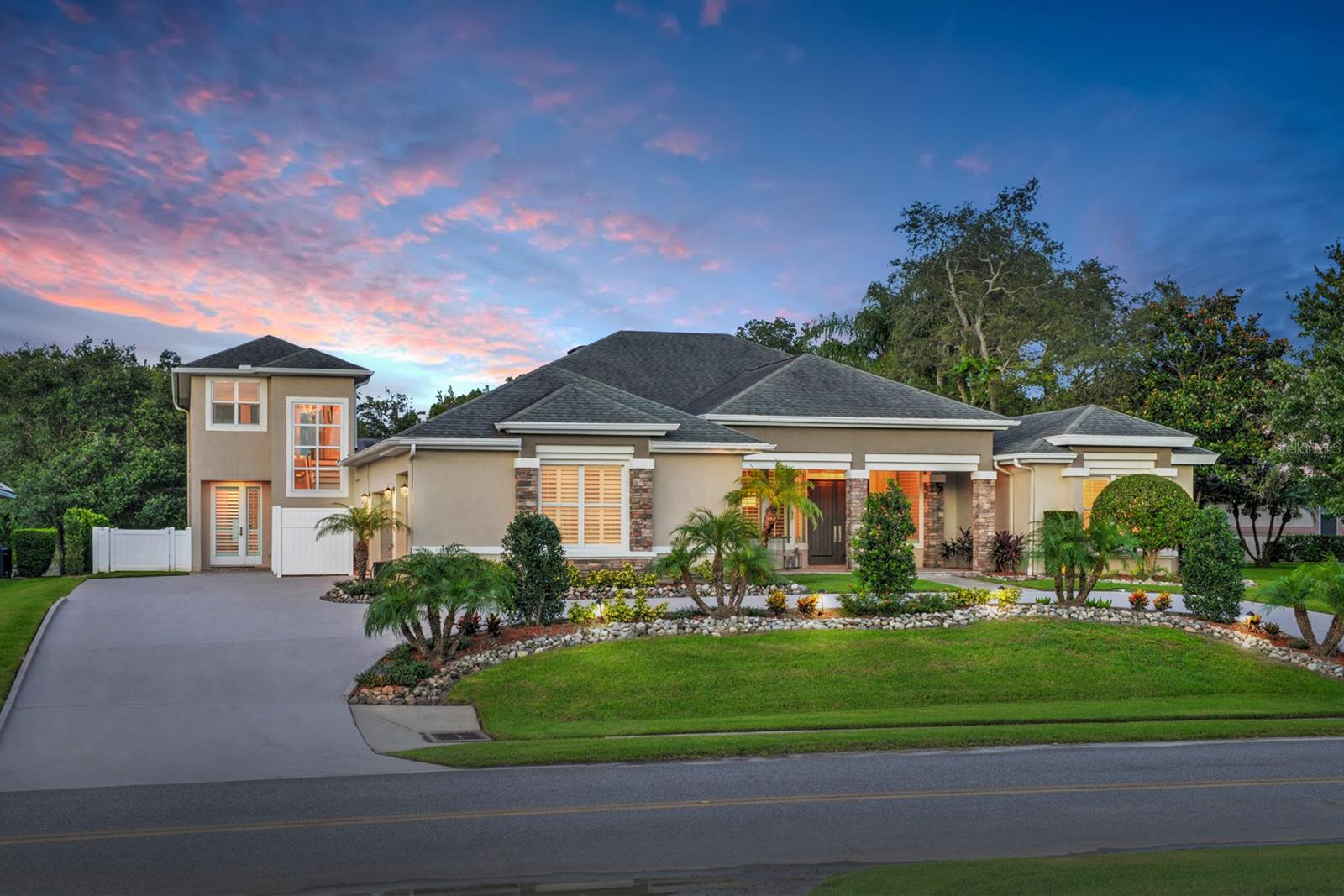 This modern residence sits on an idyllic lot with an elevation of 42 feet overlooking a lake with lighted fountain & wooded conservation area. This home offers features that were updated & remodeled in 2014 to accommodate an extended family. 2014 upgrades include: Hurricane Impact windows & sliders that are above & beyond hurricane code, roof, 2 a/c systems, glassed, enclosed air-conditioned lanai, two story guest house with 11x14 balcony overlooking backyard, pavered backyard with in-ground pool, pergola, summer kitchen w/granite counter, firepit, plantation shutters, 109 bottle Eurocave wine refrigerator, beverage center includes two beverage refrigerators along with a complete appliance package. The main residence boasts 3,976 square feet of air-conditioned living space includes the in-law/guest house that offers 822SF of living space with separate entry. The main residence boasts 2,656SF of living space along with in-law/guest apartment offering another 822 a/c sq. ft of private living space. Real hardwood flooring in living & dining rooms as well as all bedrooms. The owner's suite will not disappoint w/spa like bathroom, jetted tub, walk-in shower & walk-in closet with built-in cabinetry.  Enjoy the chef's dream kitchen with 3 separate wine refrigerators, coffee/beverage bar, breakfast bar & cafe eating area with granite table.  The climate-controlled lanai w/floor to ceiling hurricane glass presents many options for entertaining, pool, ping pong or other gaming. Custom niches, transom windows & plantation shutters. The 3-car garage is 24 ft deep offering an extra tall garage door for larger vehicles. Walk into the 1st level of the guest house to spacious living area housing the kitchen, living area with cabinetry & full bathroom & access to the pavered patio. The 2nd level of the guest house is currently used for sleeping quarters with a seating area. You will enjoy the amazing views from the balcony overlooking the deck, pool, lake, & conservation area. ;Water: City
