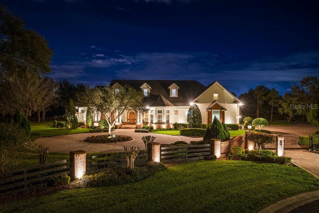 Welcome to the impressive estate of 400 Canterwood. As soon as you come in through your private community and private estate gate, you are transported to another world of luxury and quality. Walking through your custom mahogany front door, you are welcomed into the grand foyer with its opulent features such as solid hardwood flooring with its mosaic design, 12 to 18-foot high tray ceilings with custom crown molding, custom built-in bookshelves, and a direct view into your backyard oasis. Continuing through the home, you arrive at the custom gourmet kitchen that features granite countertops, 42” cabinets with slow close cabinetry, Thermador stainless steel appliances, a gas range cooktop, glass backsplash, under cabinet lighting, an impressive walk-in pantry, an enormous kitchen island with its cookbook shelf, a vegetable sink and a bar seating area- truly making this kitchen a chef’s paradise and an entertaining hub. With its split floor plan, the primary suite is on one wing of the property providing you maximum privacy. The primary suite incorporates an entrance foyer, tray ceilings, built-in shelving, crown molding, a plethora of windows providing natural light, an electric-powered fireplace, and private access to your backyard oasis. The primary bath is sure to impress with its beautiful marble flooring, high ceilings, double sink vanity, and a “princess” jacuzzi jetted tub with views to your private courtyard, allowing you to unwind from the everyday routine. This estate also features two additional bedrooms in the main home and a fourth detached bedroom perfect for a home office or an in-law suite. Movie lovers can take advantage of your in-home movie theater equipped with a 96-inch screen with a Sony high-definition projector, seven electric reclining seats, and a generous wet bar, allowing you to serve amazing snacks while viewing movies under your starlight ceiling. If this was still not enough, this estate features an additional detached structure that houses on the first level your additional eight-car garage, perfect for car enthusiasts, a tool room, and two car lifts. On your second level, accessed through your private elevator, you have an additional two-bedroom one-bath suite, with an enormous 20 by 40-foot craft room/bonus room perfect for gatherings, entertaining, or anything your heart desires! An additional full kitchen adorns this area with features such as GE profile appliances, a multitude of cabinetry for storage, and an enormous eat-in area! All of this under a tongue and grooved pine ceiling and interior walls, giving you the feeling you are in a beautiful cabin home in the mountains! Once done inside, it is time to go outside and enjoy the Florida lifestyle! Encompassing roughly 4.31 acres, you and your family will be able to enjoy the great outdoors in your own privacy. On the grounds of this estate, you also have your private 70-panel mounted solar farm, which in conjunction with your double insulated roof, helps with keeping your electric bills lower. The Florida lifestyle would not be complete without your private pool oasis with a beach-style entrance, a 12-person heated spa, and your personal rock accent waterslide. To top it all off you cannot be in a better location with easy access to the major highways, in between both Tampa and Orlando, and minutes away from retail shops and developments. All that is missing in this grand estate is you! Contact your realtor today for an exclusive showing.