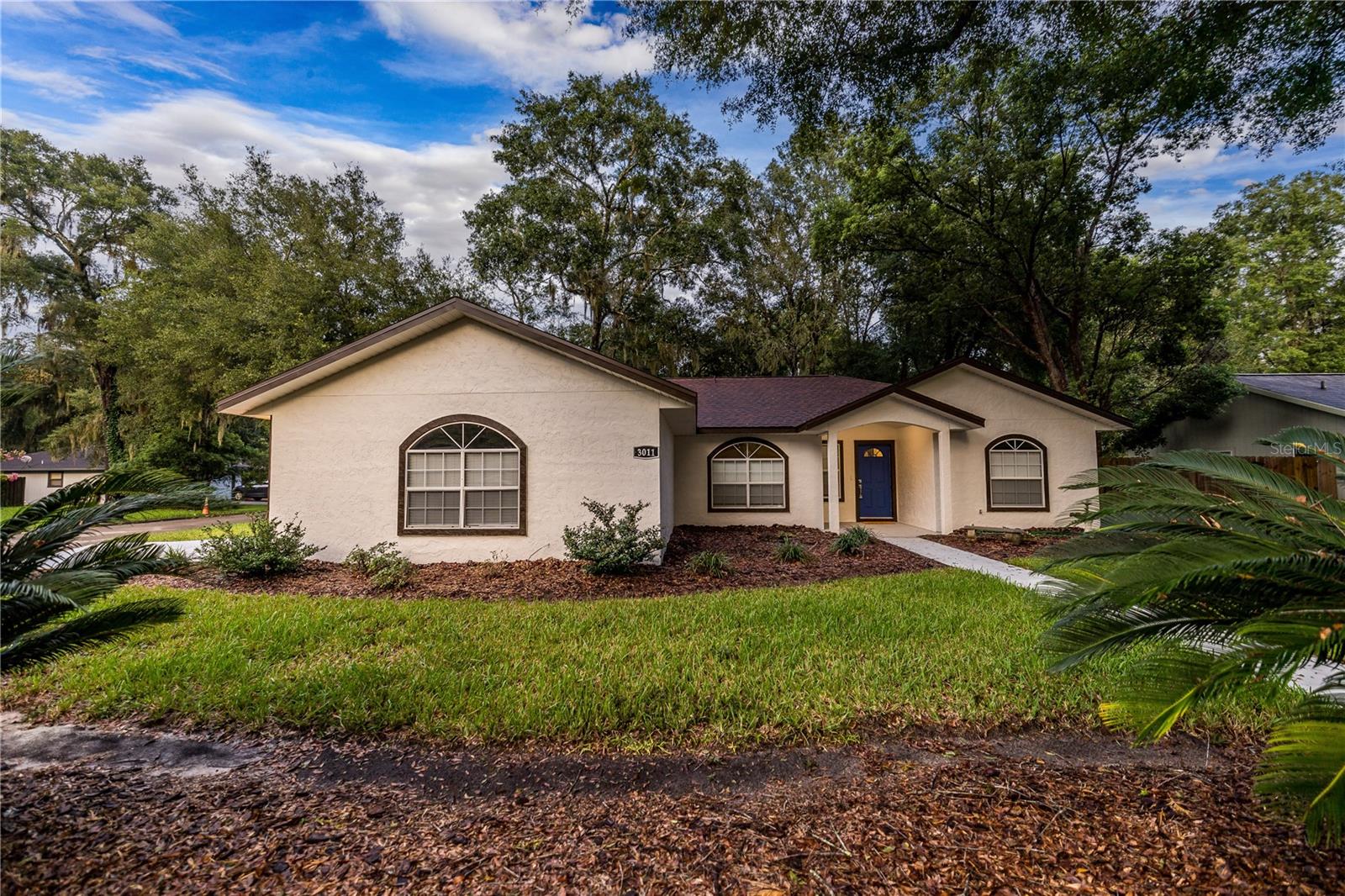 Turnkey 3-bed, 2-bath, 2- car garage, corner lot home with 1,454 sq. ft. of living space, on a nearly quarter acre lot of 10,454 sq. ft., located in the Buck Ridge West neighborhood featuring a 2020 permitted shingle roof with warranty, new vinyl flooring throughout, stainless steel appliances, new water heater, new blinds, dining nook in kitchen, fenced in yard, wood burning fireplace, laundry room, and split bedroom layout. Living and dining separated through a pony wall for an open yet private feel. The master bedroom includes a walk-in closet, a large double sink vanity, and a linen closet! The wood fenced yard features fresh landscape with mature trees and a concrete slab that is perfect for a barbecue and outdoor dining area HOA fee is only $100 annually and there are no restrictions! Don’t miss the opportunity to reside in the remarkable Gainesville neighborhood that offers an abundance of activities. Enjoy the museums, states parks, downtown, botanical gardens, and so much more. Easily access I-75 or US 441! No flood zone, no flood insurance. Easy to show, this home won’t last long!