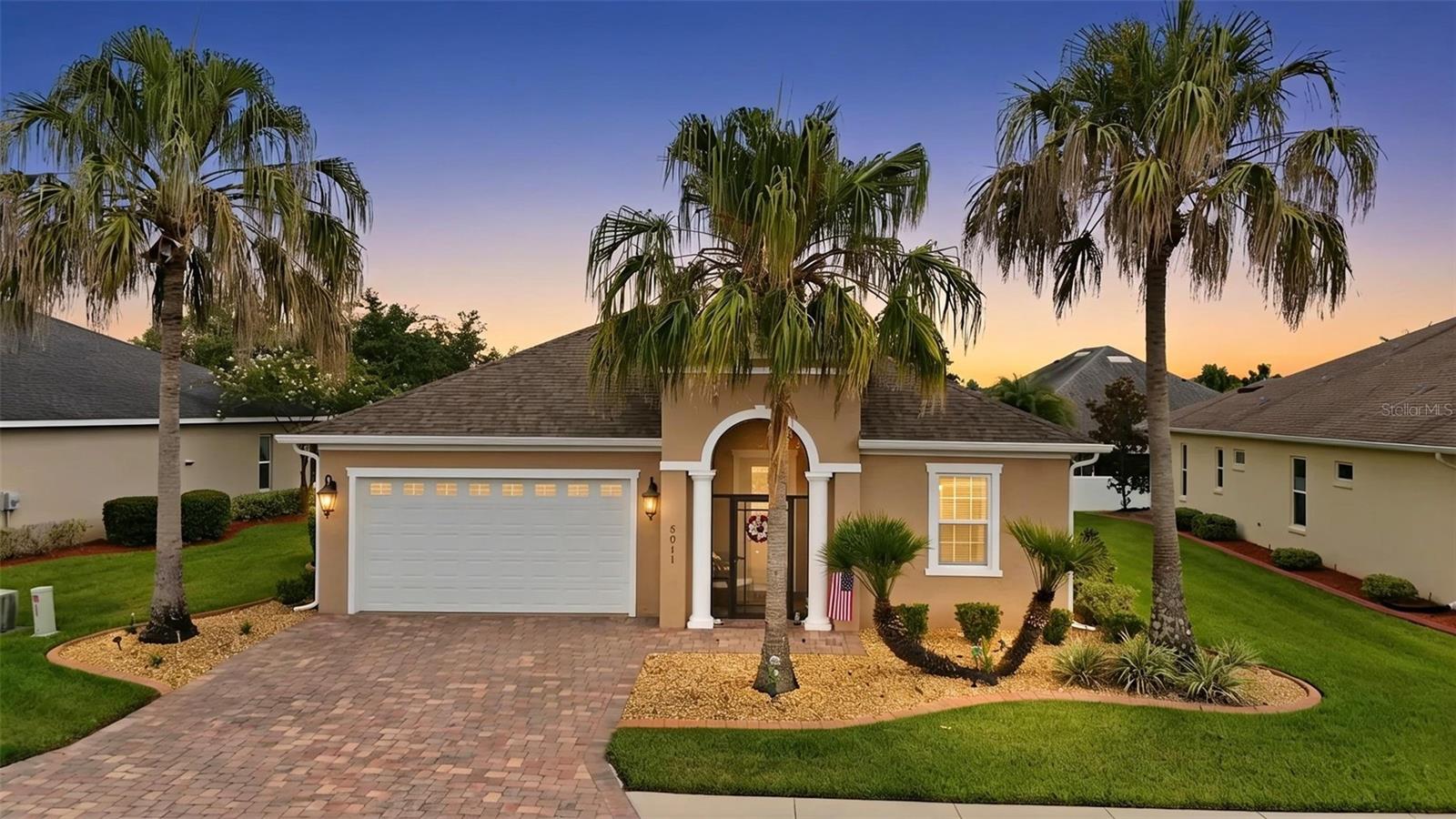 Virtually Staged. WELCOME HOME to this BEAUTIFULLY maintained 3-bedroom, 2-bath residence nestled within the highly sought-after GATED COMMUNITY of Lakeside Landings - THE ENCLAVE. Combining timeless architectural details, thoughtful upgrades, and a low-maintenance Florida lifestyle, this home is ready for its next owner. From the moment you arrive, you’ll appreciate the ATTRACTIVE CURB APPEAL featuring decorative stamped concrete landscape curbing, professionally rocked flower beds, and beautifully maintained landscaping. Relax with your morning coffee in the inviting SCREENED FRONT PORCH before stepping inside. The OPEN-CONCEPT floor plan is bright, spacious, and designed for comfortable everyday living as well as entertaining family and friends. Elegant ARCHED architectural openings add character throughout the home while large windows fill the living areas with natural light. The kitchen is both functional and inviting, offering STAINLESS STEEL appliances, abundant cabinetry, PULL-OUT CABINET drawers for added convenience, generous counter space, a breakfast bar, and an adjoining dining area that flows seamlessly into the living room. The spacious primary suite provides a relaxing retreat complete with a LARGE WALK-IN CLOSET, DUAL SINK vanity, and a WALK-IN TILED shower. Two additional bedrooms providing flexibility for guests, a home office, hobby room, or fitness space. Step outside to the SCREENED LANAI with tile flooring, where you can enjoy peaceful outdoor living and entertain year-round in your private backyard setting. ADDITIONAL IMPROVEMENTS and features include:Whole-house water softener/treatment, ADT security system,  DEDICATED indoor laundry room, NEW water heater, NEW A/C blower motor, NEW washing machine, UPGRADED back flow piping, Freshly painted exterior. Residents of Lakeside Landings enjoy an exceptional lifestyle with a 13,000-square-foot clubhouse, resort-style pool and spa, fitness center, tennis and pickleball courts, putting green, billiards room, library, banquet facilities, dog park, playground, walking areas, and an active social calendar. The HOA also includes lawn maintenance and irrigation, making homeownership even more enjoyable. Conveniently located just minutes from Lake Sumter Landing Market Square and Brownwood Paddock Square, shopping, dining, medical facilities, golf, and all the entertainment The Villages area has, this home provides the perfect balance of comfort, convenience, and community. Whether you’re searching for your year-round residence or your Florida retreat, this meticulously cared-for home is one you won’t want to miss. Schedule your private showing today!