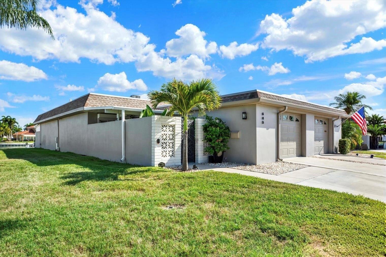 RARE opportunity to own a truly exceptional END UNIT WATERFRONT VILLA in the highly sought-after waterfront 55+ community of Boca Ciega Point! This one-of-a-kind STUNNING residence has been thoughtfully updated from top to bottom with custom-designed, high-quality finishes and offers a perfect blend of luxury, comfort, and waterfront living. A welcoming tropical courtyard sets the tone for this beautiful home, featuring a tranquil wall fountain, lush tropical landscaping, and an artist-painted cement floor. Inside, the light-filled open floor plan showcases a dreamy remodeled kitchen, with a large island, breakfast bar, abundant cabinetry, marble countertops, coordinating backsplash, and new stainless-steel appliances. The sliding glass door with built-in blinds seamlessly connects the kitchen to the outdoor patio area. The spacious dining and living areas are enhanced by a solar tube that fills the home with natural light, opening to an expansive Florida room with breathtaking, unobstructed Intracoastal Waterway views! This incredible space is designed for relaxation and entertaining, where you can enjoy spectacular sunsets, dolphin visits, and the beauty of waterfront living. Custom wall-to-wall blackout blinds provide privacy when desired. The primary suite offers direct access to the Family room, a WALK-IN CLOSET, and a beautifully updated ensuite bath. The generous 2ND bedroom provides convenient access to the private courtyard. Additional features include INTERIOR LAUNDRY, a freshly painted garage with impact door, and a driveway with parking for 2 vehicles.This home is loaded with upgrades (!) including a new water heater, roof (2018), HVAC (2017), added insulation, wood-look porcelain tile flooring, HURRICANE-IMPACT WINDOWS, solar-powered security cameras, attic fan, and more! Located near the end of the peninsula, this villa offers some of the most desirable views in the community, a PRIVATE DOCK WITH A 10,000 LB BOAT LIFT and an abundance of green space—perfect for pets and enjoying the outdoors! Boca Ciega Point is a PET-FRIENDLY 55+ community offering an impressive array of amenities including 2 clubhouses, heated pool, pickleball, tennis, bocce ball, shuffleboard, fitness center, and an active social and boating club. Ideally located just minutes to the beautiful Gulf beaches of Madeira Beach, shopping, dining, and entertainment at Seminole City Center. Schedule your private showing today and experience the best of waterfront villa living! Don’t miss this one!