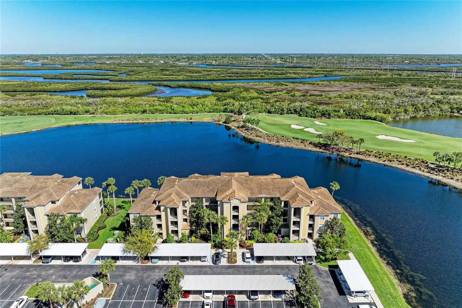 PRICE IMPROVEMENT!  Live the ultimate Florida lifestyle in this TOP FLOOR (4th level) condominium located in the highly sought-after, gated community of River Strand Golf & Country Club! Offered TURNKEY FURNISHED AND BEAUTIFULLY MAINTAINED, this home is truly MOVE IN READY and set for immediate enjoyment—just bring your suitcase.

Inside, you’ll find a thoughtfully designed layout enhanced by custom lighting, upgraded ceiling fans, and tasteful finishes that create a warm yet refined atmosphere. The kitchen with breakfast bar overlooks the large main living area connecting the great room and dining space.  The spacious primary suite features dual walk-in closets and a private en-suite bath, while the comfortable guest bedroom and full bath provide an inviting space for family or visitors.

Unwind on your private screened lanai, where SPECTACULAR VIEWS of the golf course, water, and surrounding wildlife create a serene backdrop. Overlooking the 6th hole of the Estuary Course—part of River Strand’s 27-hole championship golf offering—this setting is perfect for relaxing or entertaining.

Additional conveniences include a dedicated storage room for larger items and an assigned covered carport.

River Strand delivers a true resort-style experience with an abundance of amenities, including championship golf, tennis and pickleball courts, two resort-style pools and spas, six satellite pools, and two fully equipped fitness centers. Residents also enjoy a full calendar of social events and activities. Enhancing the experience even further is an exciting $9 million community upgrade, featuring a newly designed tiki bar, expanded outdoor dining, and a beautifully RENOVATED CLUBHOUSE WITH RESTAURANT and grille room. Conveniently located near I-75, and minutes from the new Marketplace, this home offers easy access to the to a growing selection of shopping, dining, and entertainment, as well as the stunning beaches of Florida’s Gulf Coast.  So come and enjoy the very best of resort-style living, once you experience River Strand at it's best you may never want to leave!