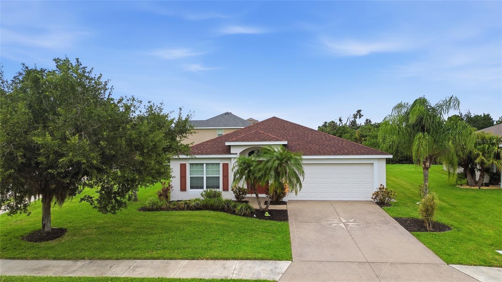Welcome home to this beautiful ranch in the Harrison Ranch community. The home is a corner property and has an oversized lot. When you first enter the home there is a large living room perfect for entertaining, the kitchen has an open concept floor plan to the eating area and family room which has sliders to the screened in lanai with patio area and fully fenced in yard. The lanai also has a doggie door, perfect for the dog! The home features 3 bedrooms and 2 full baths with the primary suite separate from the other 2 bedroom and guest bath. The primary suite is located in the back of the house and has a beautiful ensuite bath with dual sinks, separate shower, soaking tub and a walk-in-closet. There is a nice sized laundry room with washer/dryer and cabinets for storage. Large 2 car garage with epoxy flooring competes this amazing home. Updates on the home include, new roof, stove, washing machine and freshly painted exterior - all done in 2025. The Community has pool, tennis courts, clubhouse and playground all for your enjoyment, which makes this community the perfect place to call home.