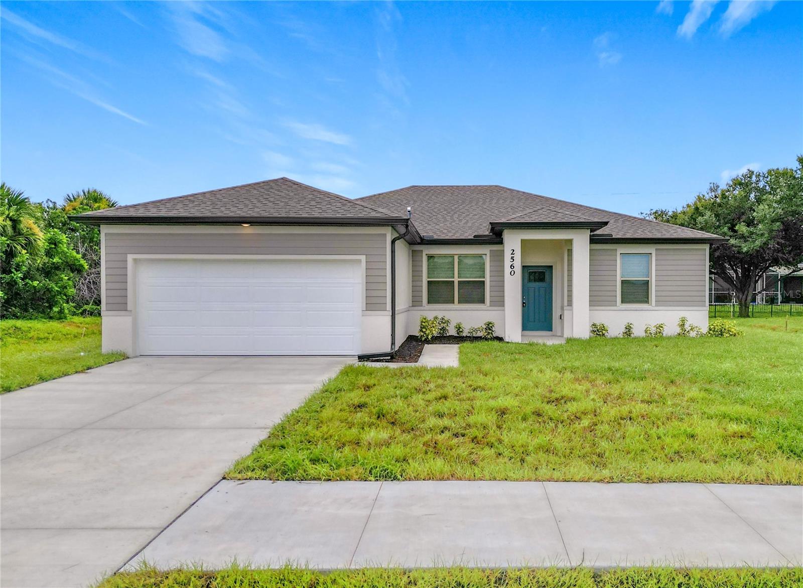 NOW OFFERING 3% TOWARDS CLOSING COSTS WITH PREFERRED LENDER. Great price with luxury features and ready now! A newly constructed home with city water and septic system in North Port, with no HOA fees! Great location for quick access to shopping, medical conveniences, parks and schools. This affordable new home is ready for you and is just what you've been looking for...No HOA and with city water! This home has 9'4" tall ceilings, a nice open layout with a versatile floor plan. The house features 4 bedrooms, 2 full bathrooms, dining room, a living room, an open kitchen and a 2-car garage with 1810 square feet of living space. The living space is well utilized with high ceilings and many windows providing natural light. The interior features will provide you with the quality and luxury you were looking for in your new home. This home has a split floor plan with the primary suite on one side of the home and the guest bedrooms on the other. The primary bedroom has a tray ceiling and large windows that bring in lots of natural light. You'll also enjoy a resort-style bathroom with a spacious walk-in shower with floor-to-ceiling tiled walls and a glass enclosure. It also features a linen closet, double vanity and a large walk-in closet. The living room features large windows and several LED fixtures providing plenty of light with access to the covered lanai. The living room is open to the kitchen, where you'll find a huge center island with extra seating for casual dining and plenty of cabinets. The kitchen features stainless steel appliances, Shaker-style cabinets with crown molding, decorative hardware, subway tile backsplash and granite countertops. The dining room is located at the front of the house, with large windows allowing for plenty of natural light. The home includes luxury vinyl plank flooring in the main living areas and bathrooms for durability and comfort. You'll love these floors! They are easy to maintain and offer a modern design, perfect for new homes. Other features include the same beautiful Shaker-style cabinets with hardware and granite countertops in the bathrooms, 5-inch baseboards, a garage door opener, gutters on the exterior, R38 insulation, a 16 SEER HVAC and much more. Visit our model center and compare the features and quality with other homes and you'll see the difference. We make buying easy for you!