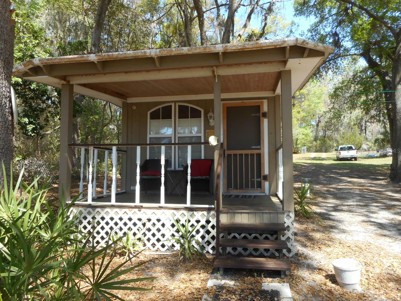 The GETAWAY.  Cottage on Tiger Lake with great mature oaks.  Fenced and ready to enjoy.  Long dock to watch the wildlife entertain.  Lake is currently low due to drought condition in the state.  Large shed with pool table.