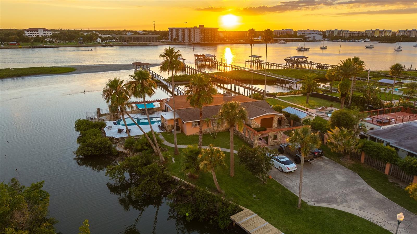 EXCLUSIVE HALF-ACRE PLUS WATERFRONT RETREAT in EMERGING NEW SMYRNA BEACH — WHERE DIRECT INTRACOASTAL ACCESS MEETS SMART LONG-TERM INVESTMENT IN A BOATER’S COASTAL PARADISE.

Tucked away on a quiet dead-end street, this rare 0.58-acre private oasis (over half an acre) commands dual waterfront frontage on both a SHELTERED CANAL AND THE INTRACOASTAL WATERWAY itself. This updated 3-bedroom, 3-bath pool home (2,391 sq ft, built 1972 with meaningful renovations) delivers immediate luxury living for discerning boaters and INVESTORS SEEKING SCARCE FLORIDA WATERFRONT WITH STRONG APPRECIATION DRIVERS.

Step into a true boater’s lifestyle: Your private canal-front dock and riverfront boathouse with dock provide seamless access to the Intracoastal Waterway’s pristine waters. Cruise to Ponce Inlet for Atlantic adventures, drop lines for world-class inshore fishing, or simply drift among dolphins, manatees, and abundant wildlife right from your backyard. UNOBSTRUCTED ICW VISTAS UNFOLD FROM THE EXPANSIVE REAR PATIO/LANAI AND THE SIGNATURE FLORIDA ROOM/RIVER ROOM — COMPLETE WITH FIREPLACE AND WET BAR — PERFECT FOR ELEVATED ENTERTAINING, SUNRISE COFFEES, OR SUNSET TOASTS OVERLOOKING YOUR DOMAIN.

Inside, sophisticated coastal character shines through wood beam ceilings, plantation shutters, an updated kitchen with granite counters and stainless appliances, two new AC units, and fresh landscaping. A long driveway offers generous parking for boats, trailers, and guests, while the private courtyard pool creates an intimate resort feel on your expansive lot.

Investment-strengthened by location and momentum: Conveniently positioned minutes from Flagler Avenue’s upscale shops and dining, pristine beaches, and vibrant Canal Street, this property also aligns with New Smyrna Beach’s forward trajectory. Ongoing FDOT infrastructure enhancements along SR 44 — including resurfacing, turn lanes, signals, and connectivity upgrades through 2030 — are UNLOCKING THE WESTERN GROWTH CORRIDOR, SUPPORTING POPULATION INFLUX, JOB CREATION, AND SUSTAINED DEMAND FOR PREMIUM WATERFRONT ASSETS LIKE THIS.

Adding further upside is NEW SMYRNA BEACH'S STRATEGIC POSITION WITHIN FLORIDA'S EXPANDING SPACE COAST ECONOMY. Located approximately 46 miles from the world-renowned Kennedy Space Center, residents enjoy front-row access to spectacular rocket launches from area beaches while benefiting from the ECONOMIC RIPPLE EFFECTS OF ONE OF THE NATION'S FASTEST-GROWING AEROSPACE CORRIDORS. VOLUSIA COUNTY IS ACTIVELY PURSUING AEROSPACE EXPANSION THROUGH INITIATIVES SUCH AS THE COMMERCIAL SPACE INDUSTRY OPPORTUNITY OVERLAY AND THE FLORIDA SPACE INNOVATION CENTER, HELPING ATTRACT INVESTMENT, INNOVATION, AND HIGH-PAYING JOBS. THE CONTINUED GROWTH OF EMPLOYERS INCLUDING NASA, SPACEX, BLUE ORIGIN, AND THEIR EXTENSIVE SUPPLIER NETWORKS IS FUELING POPULATION GROWTH, ECONOMIC DIVERSIFICATION, AND INCREASED DEMAND FOR DESIRABLE COASTAL REAL ESTATE THROUGHOUT THE REGION.

Dual-waterfront estates of this caliber with boathouse, dock, and generous acreage surface infrequently in New Smyrna Beach. SECURE IT AS YOUR PRIMARY LUXURY RESIDENCE, HIGH-END VACATION ESCAPE, OR INCOME-PRODUCING INVESTMENT (STRONG APPEAL FOR SEASONAL BOATERS AND RELOCATORS).

INTRACOASTAL LUXURY. BOATER’S DOMAIN. GROWTH-ORIENTED INVESTMENT.

Schedule a private tour TODAY. This isn’t just a property — it’s your gateway to an exceptional Florida waterfront legacy with built-in upside.
