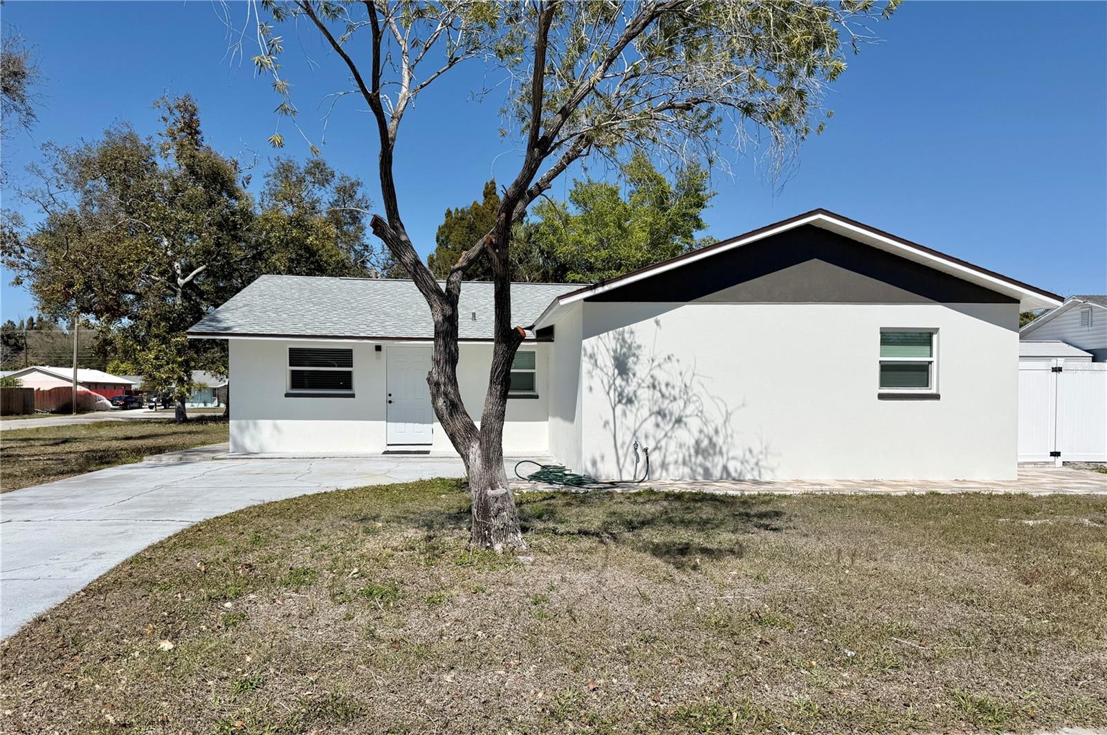 Completely renovated 4-bedroom, 3-bathroom home located in the heart of Bradenton! This move-in ready property features a modern open concept floor plan with stunning large format porcelain tile flooring throughout and abundant natural light.

The fully updated kitchen showcases sleek quartz countertops, custom wood cabinetry, stainless steel appliances, designer pendant lighting, and a spacious island perfect for entertaining. The open living and dining areas flow seamlessly to the backyard through sliding glass doors, creating ideal indoor and outdoor living.

All three bathrooms have been beautifully remodeled with contemporary finishes, including floor-to-ceiling tiled walk-in showers, modern vanities, upgraded fixtures, and stylish lighting.

Exterior features include a fresh modern façade, extended paver patio areas, and a fenced backyard offering privacy and space to relax or entertain. The large lot provides ample room for pets, play, or future additions.

Conveniently located near shopping, dining, schools, and just a short drive to Gulf beaches.
