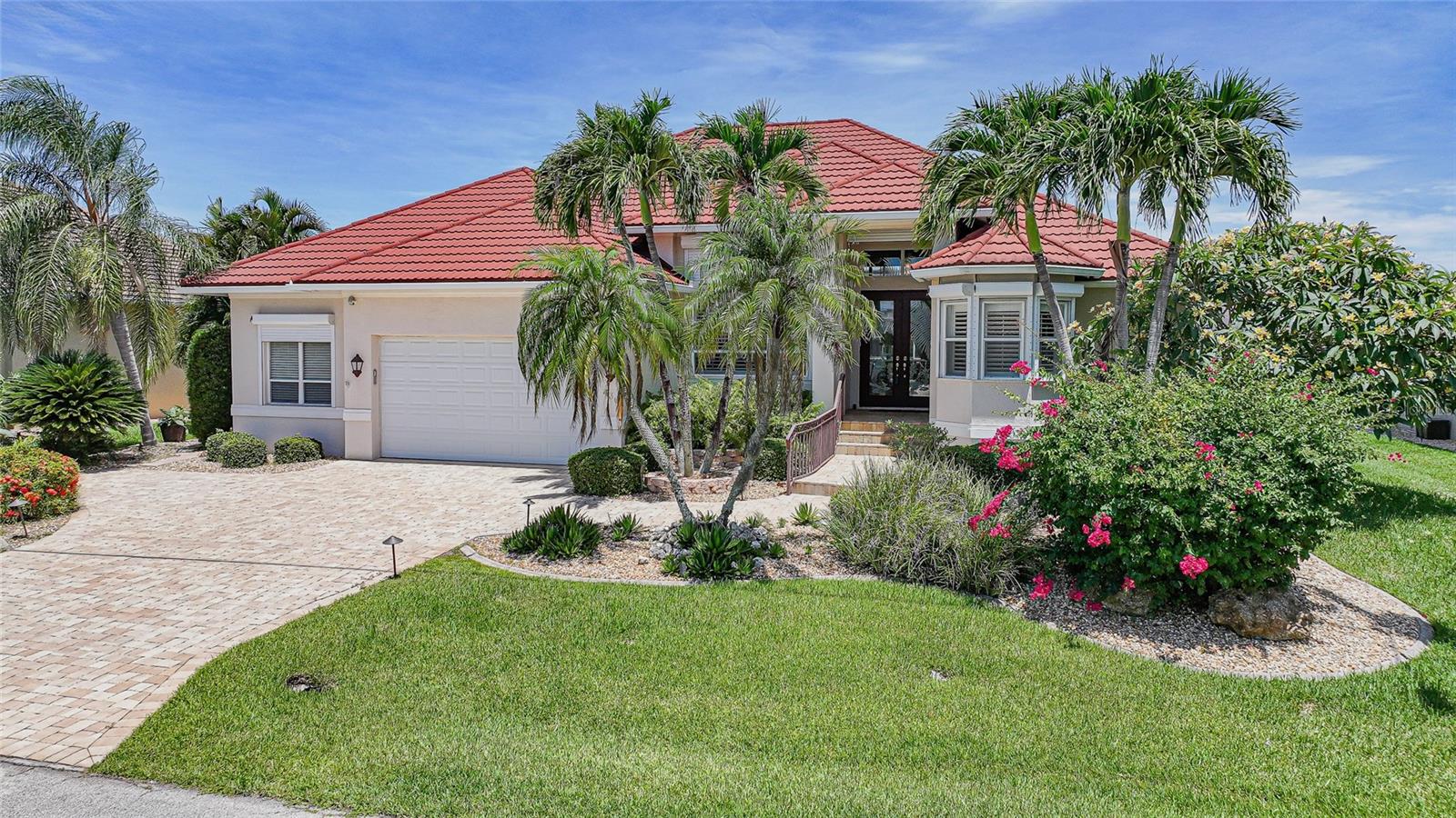 Waterfront Luxury Living with Sailboat Access!
Offered fully furnished and truly turn-key, this custom-built 3-bedroom + Office, 2.5-bath waterfront residence is perfectly positioned in one of Punta Gorda’s most sought-after boating communities. Boasting nearly 2,750 square feet of beautifully designed living space, this exceptional home features an oversized 2-car garage measuring 30' x 21' and is ideally situated in a quiet street on a deep-water canal with direct sailboat access to Charlotte Harbor and the Gulf.
Designed for the Florida lifestyle, the property offers 96 feet of city-maintained concrete seawall, a spacious 45-foot dock, and a 12,000-pound boat lift—perfect for avid boaters and anglers alike.
Step through the impressive glass double entry doors into an elegant Great room floor plan where soaring ceilings, abundant natural light, and panoramic water views create an inviting atmosphere. The expansive living area features custom cabinetry and shelving. A home office with built-in shelving is located adjacent to the living room. It can also be used as an additional guest bedroom.
The chef’s kitchen is sure to impress with stainless appliances including a Viking gas range and vent hood, built-in microwave, new refrigerator, wine cooler, center island with prep sink, convenient pull-out pantry drawers, and a breakfast bar ideal for casual dining and entertaining. Adjacent to the kitchen, the dining area is highlighted by a stunning aquarium window and sliding glass doors that seamlessly blend indoor and outdoor living.
The spacious primary suite is a private waterfront retreat, offering direct lanai access, tray ceilings, a comfortable sitting area, dual entry walk-in closets with custom built-ins, and a spa-inspired bath complete with dual vanities, a private water closet, linen storage, and an oversized walk-in shower with dual shower heads.
Guests will appreciate the thoughtfully designed split-bedroom floor plan. One guest suite features an adjoining 10' x 10' bonus room, perfect for a home office, fitness room, or private sitting area. A second guest bedroom enjoys easy access to a nearby full bath, and also has its own private half bath with convenient pool access.
Outdoor living is equally impressive with an oversized screened lanai with a large, heated pool and spa. Totally designed for relaxing or entertaining while taking in the tranquil water views, spectacular sunsets, and peaceful surroundings. Whether enjoying a morning coffee, hosting family and friends, or casting a line from your private dock, this home truly embraces the Southwest Florida waterfront lifestyle.
Additional features include a durable metal roof, complete hurricane protection with electric roll-down and accordion shutters, an in-ground propane tank, irrigation system, plantation shutters throughout, and mature landscaping.
Located in a beautifully maintained golf and boating community, residents enjoy close proximity to shopping, restaurants, parks, medical facilities, Fishermen’s Village, the historic downtown Punta Gorda district, and endless year-round community events. Optional membership to the nearby Twin Isles Country Club provides optional membership to championship golf, tennis, swimming, and an elegant clubhouse.
This exceptional waterfront property offers the perfect blend of luxury, comfort, and the ultimate Florida boating lifestyle. Meticulously maintained with pride in ownership. Schedule your private showing today!