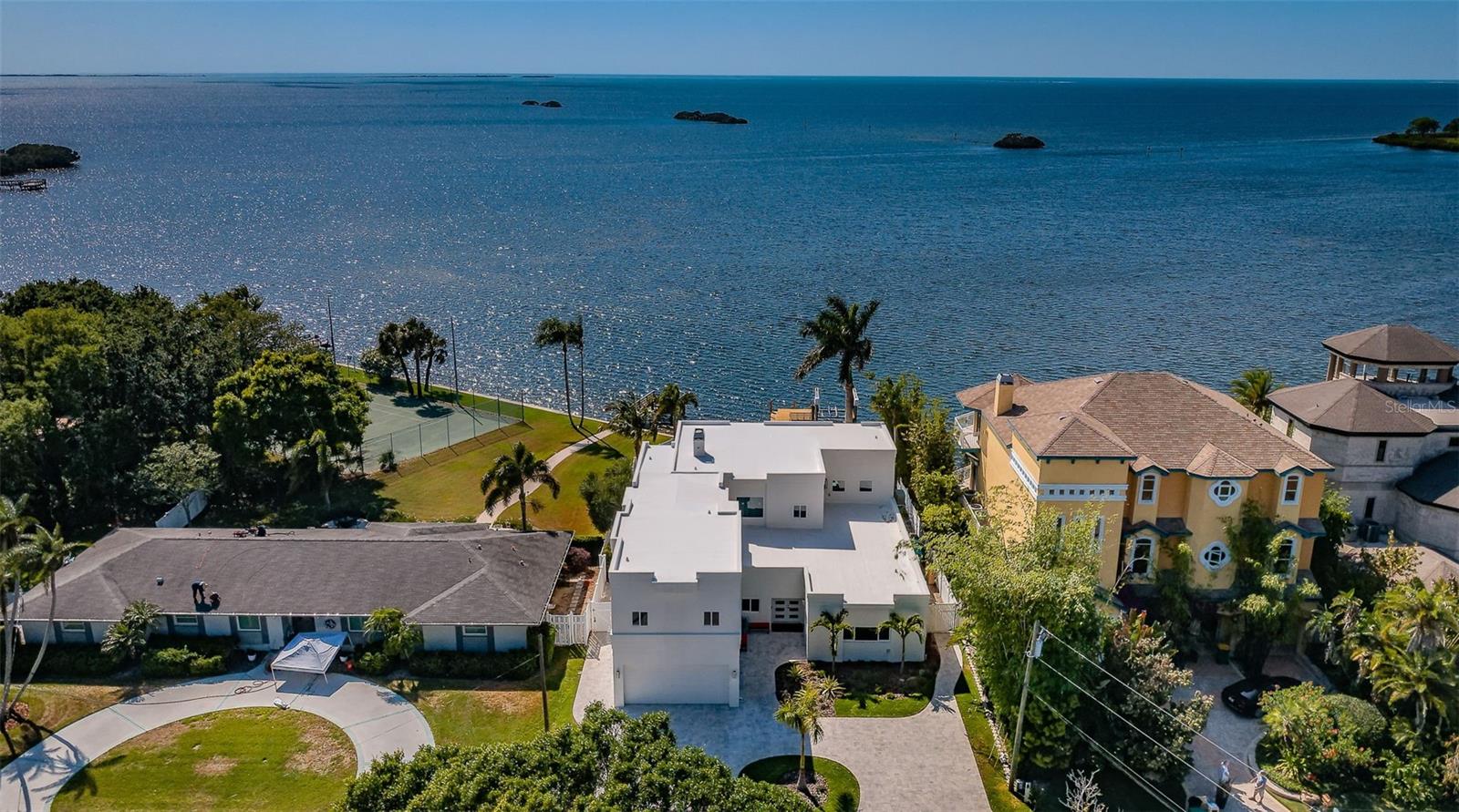 This is an incredibly exceptional home that stands out from the rest! If you love magical sunsets on the water while making special memories with family and friends, this is Your home! An entertainers dream home that has been completely updated to enhance your Gulf Front living experience! The first thing you will notice when entering this outstanding house are the Views and all the Natural light coming from the HUGE New windows! Featuring solid block construction, it is a masterful achievement of concept and design! This contemporary 4,657 square foot, 2-story West facing premiere Gulf front residence has been renovated extensively, with well over a $1,000,000++ invested in updating the house to better emphasize living on the water! Featuring Spectacular sunsets daily, this home showcases exceptional craftsmanship & design to take advantage of cool western breezes and exceptional wide-open views of the Gulf of Mexico! A partial list the improvements completed in 2022/23 included ALL new impact windows and doors throughout! NEW 22 KW whole home backup generator and NEW saltwater pool and spa systems. NEW landscaping, irrigation systems and lighting featuring a new paver driveway. The reconfigured lower level now features a NEW 5th bathroom and New dining room overlooking looking the Gulf of Mexico, and 3 additional bedrooms!  You can watch the sunsets in the NEW kitchen featuring NEW appliances, cabinets, and custom granite and tilework! A NEW whole-home water softener and filtration system and a NEW massive walk-in custom pantry help make cooking and entertaining a breeze!!  NEW 24X48 Brazilian tile flooring throughout the house. You will stay cool with 2 New HVAC systems featuring Wi-Fi compatibility and humidity control! While entertaining you will not have to worry about running out of ice because you have a NEW free-standing, high-volume icemaker! NEW custom made, Solid Wood Shaker doors and 8-inch trim throughout. Watch the MOST amazing sunsets and the dolphins playing from your Private deck on the second story Master Suite! Featuring a see-through railing system reminiscent of being a on cruise ship… without the rocking! The views keep coming for you in the Master Bathroom featuring a New HUGE 2 head walk-in shower highlighted with custom tile work and a 2-person Spa Two! Two tankless hot water systems supply plenty of hot water for the entire house! Of course, you have 2 NEW designer vanities and custom lighting! Your very spacious Master suite also has a huge walk-in closet with a kitchenet and separate dressing room! The upstairs also hosts 2 additional bedrooms complete with a separate ‘kids’ lounge! The entire interior was retextured and painted to emphasize your views. The exterior was coated was with a waterproof membrane and painted. The existing dock features a 10K pound lift with a remote control! A deepwater channel gives you easy access to the barrier Islands and the Gulf of Mexico! This outstanding home was redesigned to make your living on the water as worry free as possible! Palm Harbor boasts 210-acre Wall Springs Park includes a natural spring, minutes to the Sponge Docks, Pinellas County trail & highly rated restaurants. Minutes from Tampa International Airport.