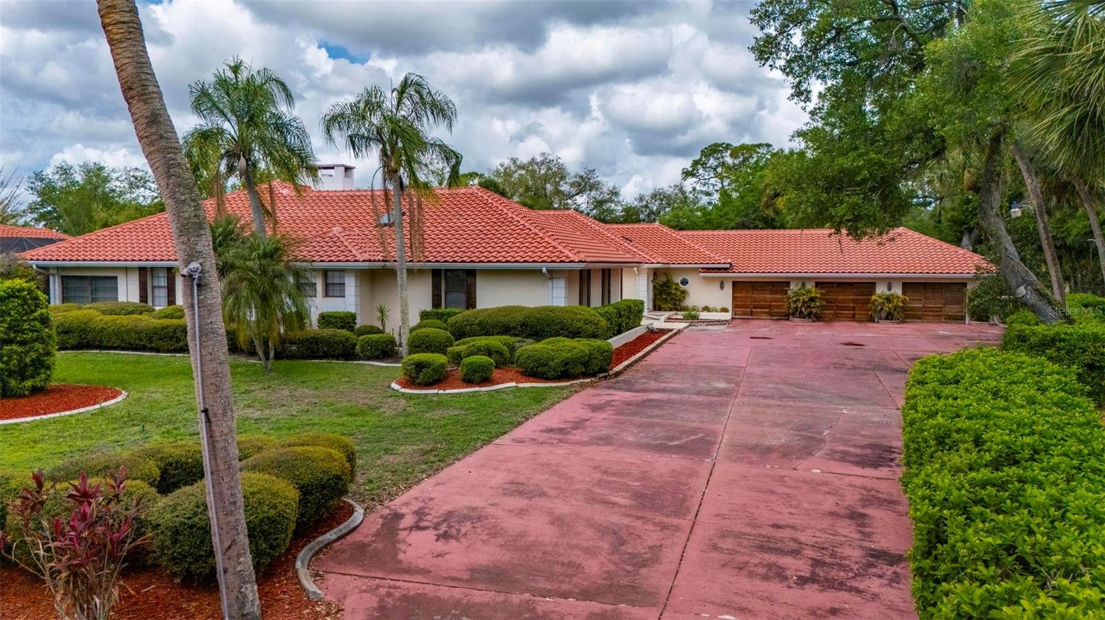 Set on a rare and expansive 5.4-acre parcel in the heart of town, this private gated estate unfolds as a world of its own, offering a 5,800sqft MAIN residence, a 3,000sqft GUEST HOUSE, and a separate 2 bedroom, 2 bathroom CABANA with its own kitchen. Across these distinct living spaces, the property features a total of 9 bedrooms, 8.5 baths, and 3 kitchens, creating an exceptional opportunity for a multigenerational estate, family compound, or income-producing property with flexible living arrangements. The true rarity of this property lies in its combination of acreage and location. Large parcels this close to shopping, dining, medical facilities, and everyday conveniences, with easy access to Punta Gorda Airport and I-75, are increasingly hard to find, yet this estate offers both privacy and accessibility. A private gate opens to a hedgerow-lined drive, introducing a sense of arrival that defines this unique property. The architecture reflects a Spanish Mediterranean style, rich with old world charm, timeless design, and custom architectural details throughout. The main residence is both spacious and inviting, designed with a traditional floor plan that emphasizes privacy and function. Each bedroom suite is set apart, while the formal living room, formal dining room, and Florida room are thoughtfully separated, creating defined spaces ideal for both everyday living and entertaining. The formal living room features a wood burning fireplace, while the dining room is enhanced by a mirrored wall that adds light and dimension. At the heart of the home, the chef’s kitchen blends European design with modern convenience. A large tile inlaid island serves as a central gathering space, complemented by high end stainless steel appliances and commercial grade features, making it ideal for entertaining, hosting, and culinary enthusiasts. Plus, a 6x17 WINE CELLAR temperature controlled with seperate seating area above it. Within the main home one of the guests bedrooms also has a private entrance, a seperate living room, and it's own bathroom en-suite. Outdoor living is equally impressive, with a LIMO size 3 car garage, and a 50X100 foot lanai that frames a RESORT STYLE POOL, covered lounge areas, and a fully equipped summer kitchen. This outdoor entertaining space is designed for large gatherings, events, and year round enjoyment. The cabana offers additional guest accommodations with its own kitchen, 2 bedrooms, 2 bathrooms, and a dedicated barbecue area and with French doors overlooking the pool, enhancing the property’s versatility. Nestled among mature oak trees, the guest house provides a private and comfortable retreat. This GUEST HOME includes 3 bedrooms, 3.5 baths, a two car garage, and a wood burning fireplace. A second floor family room with a bonus space offers flexibility for a game room, home office, or studio, making it ideal as a rental property, guest quarters, or extended family residence. The grounds also feature a PRIVATE TENNIS COURT, with the potential to be converted into a multi functional sports court, adding to the recreational appeal of this expansive property. This is a rare opportunity to own a large acreage property in a prime location, offering privacy, multiple residences, and endless potential. Whether envisioned as a luxury estate, investment property, or legacy compound, this one of a kind offering combines space, character, and convenience in a way that is seldom available.