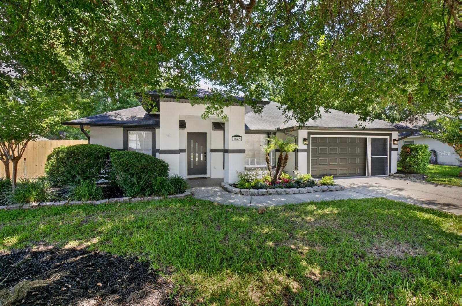 Virtually Staged. Welcome home to this beautifully renovated 3-bedroom, 2-bathroom residence in the heart of Winter Garden! Ideally located just 6 minutes from the charm and excitement of Plant Street and Downtown Winter Garden, you'll enjoy easy access to award-winning restaurants, local boutiques, the weekly farmers market, and community events while still having a peaceful place to call home. Inside, this move-in ready home has been completely transformed from top to bottom. Updates include new flooring throughout, fresh interior paint, updated baseboards, stylish new ceiling fans, and new blinds. The stunning kitchen features new appliances, upgraded countertops, and a designer backsplash, creating a space that's both functional and beautiful. Both bathrooms have been fully renovated with modern finishes, offering a fresh and luxurious feel. The improvements continue outside with fresh exterior paint, professional landscaping, a welcoming new front door, and a LeafFilter gutter protection system for added convenience and peace of mind. Step into the oversized backyard, where mature trees provide shade and character, and you'll find plenty of space to design the pool of your dreams, create an outdoor entertaining area, or simply enjoy the privacy and tranquility of your own backyard retreat. With extensive updates, an unbeatable location, and a spacious lot, this Winter Garden gem offers the perfect blend of comfort, style, and convenience. Roof 2018, Hot Water Heater 2026. Don't miss your opportunity to make it yours!