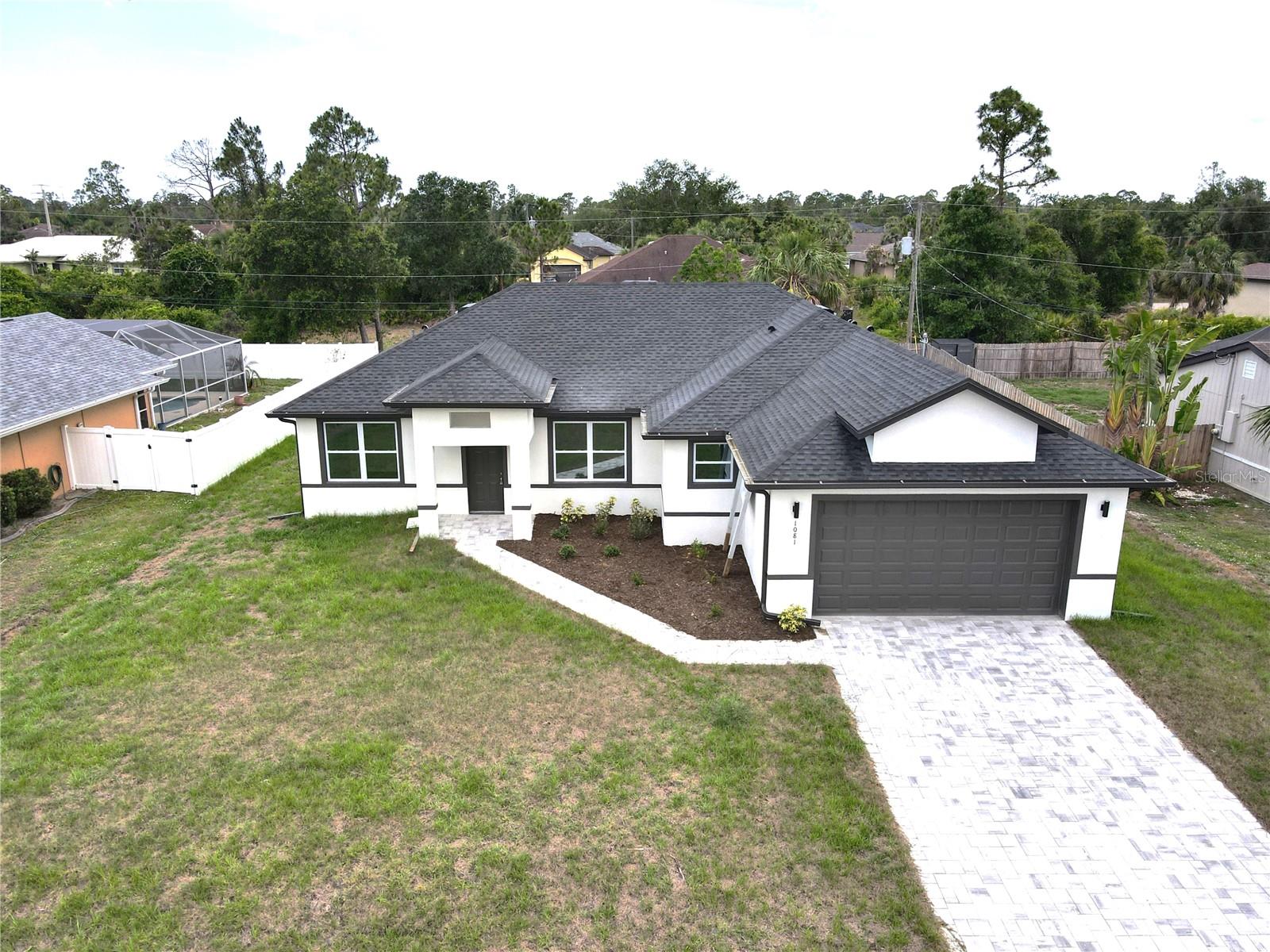 One of North Port's finest homes. Discover a blend of style, comfort and functionality in this exceptional four-bedroom, three-bath residence by ST HOMES. Designed with an open-concept layout, this home is filled with natural light and offers a seamless flow ideal for everyday living and entertaining. A welcoming foyer opens to a spacious, sun-filled living room with expansive windows. The gourmet kitchen features top-of-the-line appliances, a large center island and abundant cabinetry, flowing effortlessly into the dining and living areas, ideal for hosting gatherings or enjoying quality family time. The primary suite is a private retreat with a luxurious bath offering a soaking tub, walk-in shower and dual vanities. Three additional bedrooms provide generous space for family or guests. Beautifully designed and move-in ready, this home stands out as one of the best opportunities in North Port. Priced to sell!