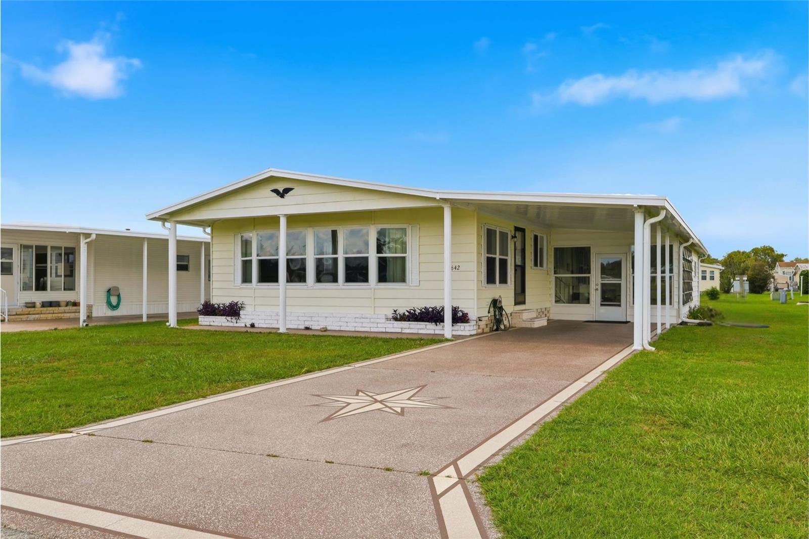 Welcome to your peaceful retreat in the desirable Lake Betmar community! This well-maintained 2-bedroom, 2-bath double-wide home offers the perfect blend of comfort, convenience, and Florida charm. Ideally situated overlooking a tranquil pond and the community's Memorial Walkway, you'll enjoy beautiful views and a serene setting right from your own home. Inside, you'll find a bright and inviting floor plan featuring beautiful bay windows that fill the home with natural light. The spacious kitchen is equipped with a center island, offering plenty of counter space for meal preparation and entertaining. The home is partially furnished, making your move easy, and a newer roof provides added value and peace of mind. The relaxing Florida room is the perfect place to enjoy your morning coffee or unwind at the end of the day, while the attached storage room provides plenty of space for tools, hobbies, or seasonal décor. Located in the highly sought-after resident-owned 55+ community of Lake Betmar, you'll enjoy an active lifestyle with outstanding amenities, including swimming pools, executive golf courses, pickleball and tennis courts, shuffleboard, clubhouses, planned social activities, and clubs to match every interest. Best of all, you own your land no lot rent! Conveniently located near shopping, dining, medical facilities, and major highways, this home offers easy access to Tampa, Orlando, and Florida's beautiful Gulf Coast beaches. Whether you're looking for a full-time residence or the perfect seasonal escape, this move-in-ready home offers the Florida lifestyle you've been dreaming of. Schedule your private showing today!