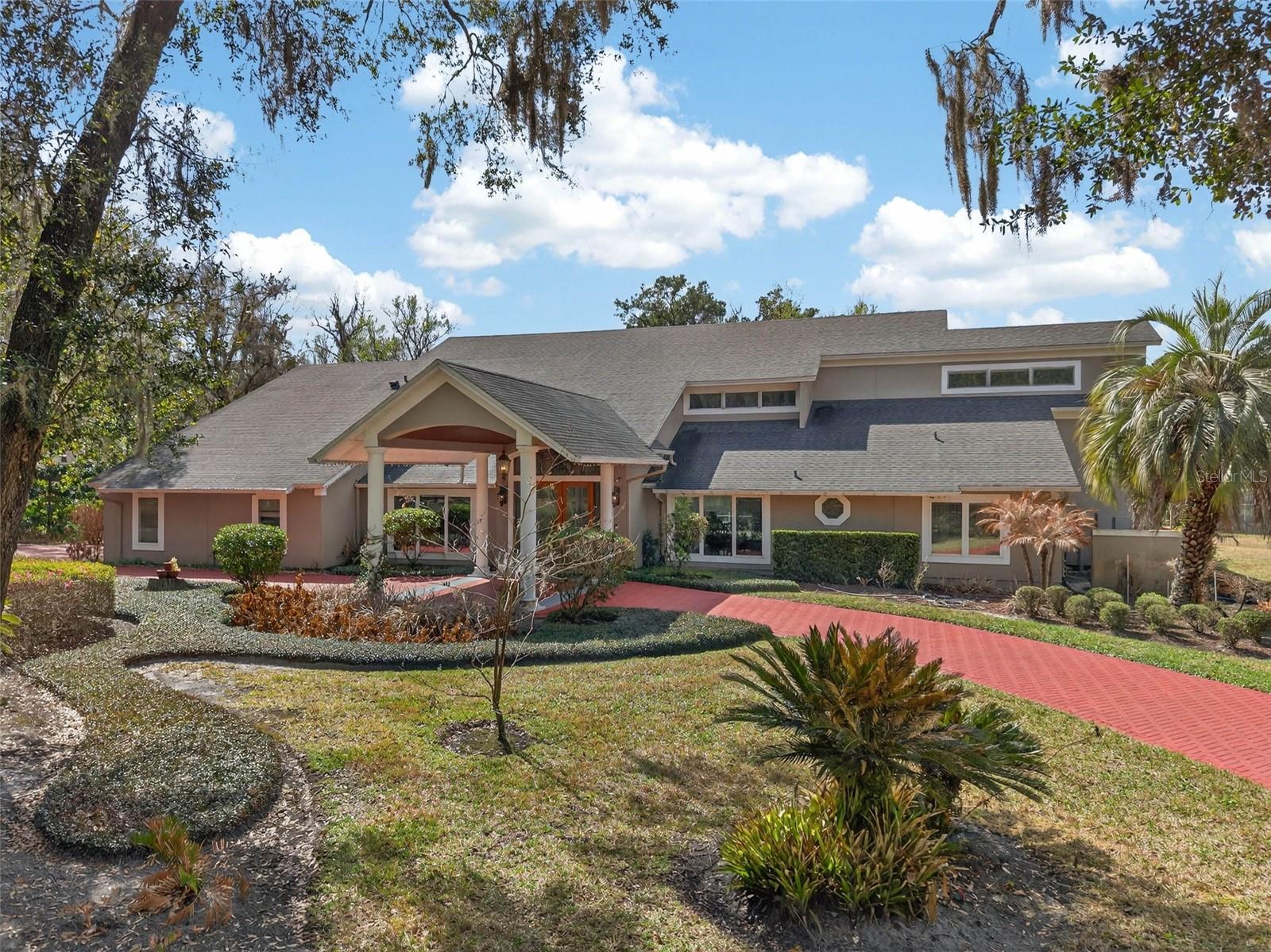 Motivated Seller. Welcome to this EXQUISITE, one-of-a-kind estate nestled within the highly regarded community of WINGFIELD RESERVE. Set on a sprawling 1.4-ACRE LOT in one of Longwood’s most sought-after enclaves, this STELLAR 6,300+ SQ. FT. home offers unparalleled grandeur and privacy. The journey begins as you traverse a FULLY PAVED CIRCULAR DRIVEWAY, framed by towering mature trees and meticulously manicured landscaping that creates a STUNNING approach to the home’s entryway. With a NEW ROOF INSTALLED IN 2019, this property seamlessly blends timeless elegance with modern peace of mind.

**The wonderful property has been recently improved with a RAPID ELECTRIC CAR CHARGER, NEW POOL HEATER, NEW BURIED PROPANE TANK, and LANDSCAPE IMPROVEMENTS!** You’ll also love the PICTURESQUE WATER VIEWS from your backyard!

Upon entering through the grand DOUBLE GLASS DOORS, you are greeted by an OVERSIZED FOYER that showcases PRISTINE MARBLE AND TRAVERTINE flooring. The WINDOWS HAVE BEEN REPLACED WITH ENERGY-SAVING VINYL FRAMED WINDOWS. A magnificent HARDWOOD STAIRCASE, accented by BLACK WROUGHT IRON BALUSTERS, leads you to the sanctuary of the PRIMARY BEDROOM SUITE. This private retreat is a masterclass in luxury, featuring HARDWOOD FLOORS, HIGH CEILINGS with CRISP RECESSED LIGHTING, and a cozy GAS FIREPLACE for quiet evenings. The PRIMARY BATH offers a true spa experience with a SPA SOAKING TUB and an OVERSIZED STEAM SHOWER with FRAMELESS GLASS DOORS, leading to a LARGE WALK-IN CLOSET with CUSTOM CABINETRY and a convenient LAUNDRY CHUTE.

The heart of the home is a GOURMET KITCHEN designed for the culinary enthusiast. It features a massive 8-FOOT GRANITE KITCHEN ISLAND with integrated storage, CUSTOM CABINETS WITH GLASS INSERTS, and a suite of professional-grade STAINLESS STEEL APPLIANCES, including a SUB-ZERO REFRIGERATOR, 2 BOSCH DISHWASHERS, and a 5-BURNER GAS STOVE. Adjacent to the kitchen, a substantial WALK-IN PANTRY provides a STAND-UP FREEZER and additional granite workspace.

For entertaining, the opposite wing of the house boasts a SUBSTANTIAL GAME AND ENTERTAINING ROOM complete with a WET BAR, BAR FRIDGE, and fireplace, while the upstairs offers a LARGE EXERCISE ROOM and an OVERSIZED MULTI-PURPOSE ROOM featuring a VERY INTERESTING FEATURE that must be seen in person to be fully appreciated.

The luxury extends to the outdoor oasis, where a SALTWATER POOL AND SPA serve as the centerpiece of a LARGE AREA LANAI. Hosting is made effortless by the INCREDIBLE RUSTIC STONED OUTDOOR GOURMET KITCHEN, equipped with a high-performance SOLAIRE INFRARED GRILL. Residents of WINGFIELD RESERVE also benefit from the community's reputation for privacy and its proximity to the natural beauty of the WEKIVA RIVER buffer and TOP-RATED SEMINOLE COUNTY SCHOOLS.

1700 ALVARADO is an EXCEPTIONAL property and a true must-see. Call today to schedule a visit!