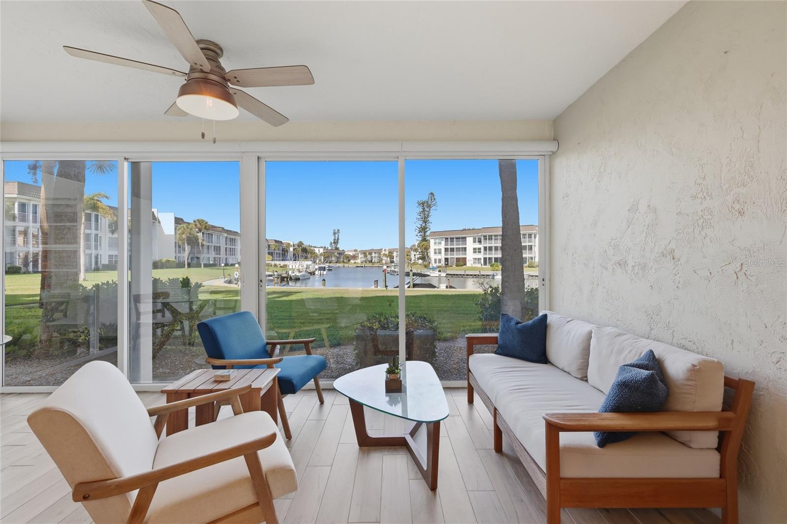 Located in the gated waterfront community of Longboat Harbour, this updated first floor residence offers direct walkout access to manicured green space and peaceful water views. Positioned near deeded beach access, the home provides a seamless blend of coastal living and everyday convenience.
Interior features include tile flooring throughout, Frigidaire appliances, plantation shutters and automated blinds. The residence is offered turnkey furnished, including a West Elm leather sofa, coordinated coastal accent tables, coffee table, breakfast set and dining table with six chairs. The air conditioning system was replaced approximately two and a half years ago. All appliances and the hot water heater are under warranty, including parts and labor, through February 2027.
Covered assigned parking and ample guest parking are included.
Longboat Harbour is home to the Longboat Yacht Club, offering an active social calendar and waterfront gatherings for residents, whether or not they maintain a slip. Dock slips are available on a first-come basis for $460 per year. Community amenities include kayak storage and launch, seasonal dock rentals, a fitness center with instructor-led classes, tennis and pickleball courts, sauna, craft room, woodshop, library, and game rooms.

No pets permitted. Rentals allowed twice annually with a 30 day minimum.