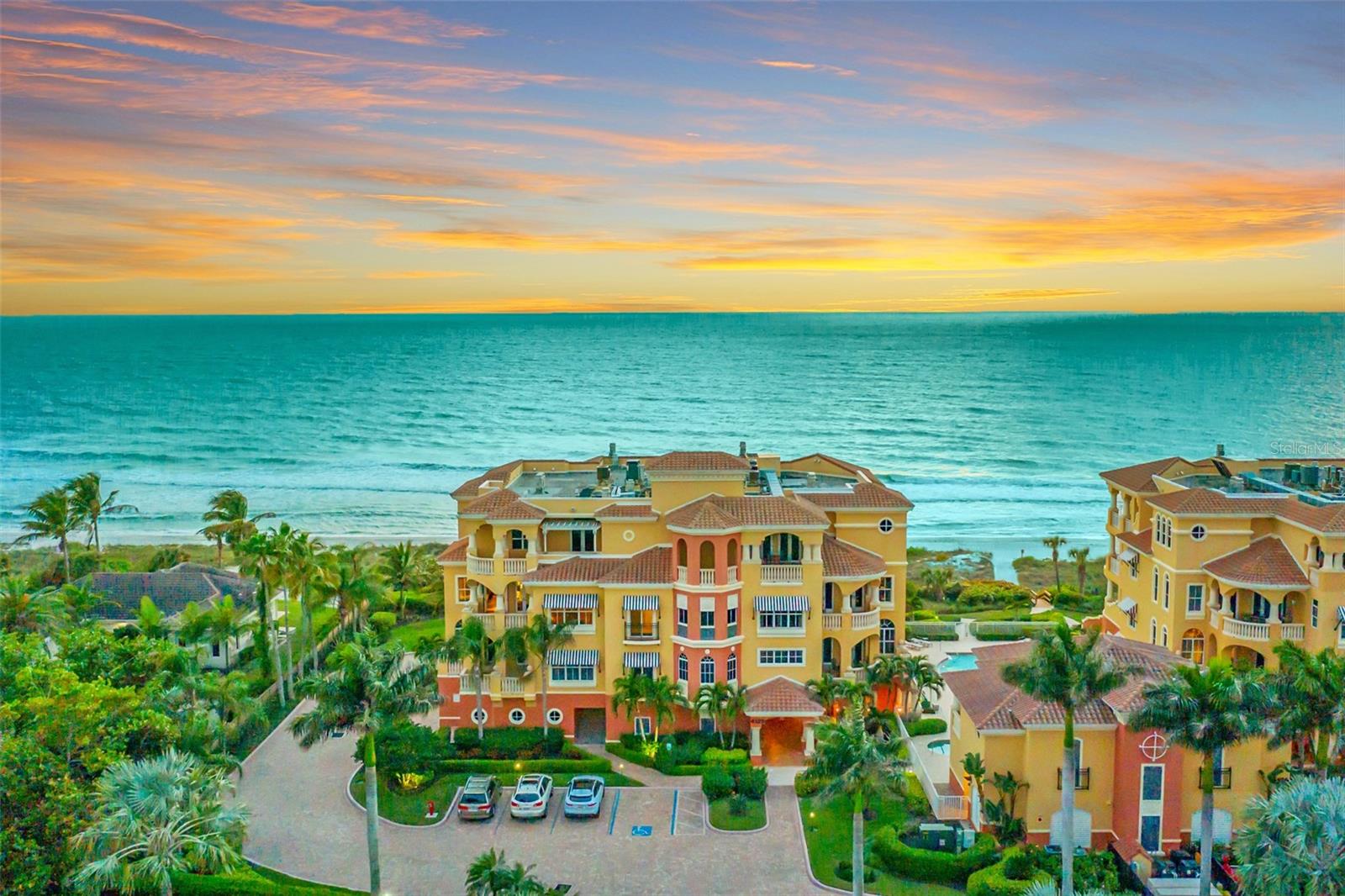 This remarkable La Firenza residence, one of only 10 in this boutique community, offers over 3,500 square feet of refined, air-conditioned living space. Ideally positioned on the desired southwest corner, it boasts wraparound, unobstructed views of the gulf and Longboat Key. The villa-like architecture and meticulously designed grounds exude timeless elegance, seamlessly carried into the home’s interior. This remarkable unit is being sold turnkey furnished for your immediate enjoyment! Sophisticated details such as tray ceilings, arched windows, crown molding and stately columns enhance the residence’s spacious layout, all while framing breathtaking water vistas. With soaring 10-foot and 11-foot ceilings and nearly every room opening to an outdoor terrace, the home’s grandeur balances effortlessly with the relaxed luxury of Longboat Key living. Accessed via a private elevator, the expansive foyer leads to a central living area that opens onto a gulf-facing terrace. This elegant home features three large en-suite bedrooms, thoughtfully arranged for optimal privacy. The primary suite, a tranquil retreat, offers space for a sitting area, direct access to the gulf-front terrace, dual walk-in closets with custom shelving and an opulent primary bath featuring a soaking tub, separate vanities and a cosmetic vanity. The additional bedrooms, each with walk-in closets, enjoy direct access to the eastern terrace and sweeping views of Sarasota Bay. The chef’s kitchen is a standout, with a substantial island, luxury gas range, premium vent hood, granite countertops and fine cabinetry. A breakfast alcove opens to the gulf terrace, while a cozy media den connects to the bayside terrace. A wet bar with matching cabinetry, granite accents, generous storage and dual beverage refrigerators elevates the home’s entertainment possibilities. Outdoor living is equally spectacular. The expansive beachfront terrace features a summer kitchen with a gas grill, ideal for hosting. On the east-facing terrace, panoramic views of Sarasota Bay create a serene backdrop. Additional highlights include a private office alcove, travertine flooring, louvered shutters, a dedicated laundry room with a utility sink and a private two-car garage. On an exclusive stretch of Longboat Key, La Firenza is a secure, luxurious retreat. Residents enjoy private beach access, a serene pool and hot tub, fitness center, shared lounge, a staffed gatehouse and covered parking. Blending grandeur and comfort, this home offers a sophisticated oasis moments from Longboat Key’s vibrant social and recreational amenities.
