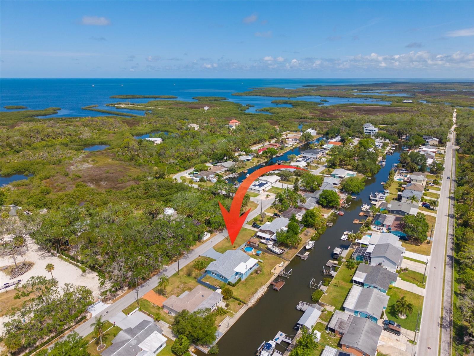 Are you looking for a place to park your toys AND live the salt life!? Welcome to your ultimate coastal retreat in the heart of Port Richey! This meticulously maintained 2-bedroom, 2.5-bathroom home sits on an expansive double lot with 124 feet of saltwater canal waterfront, just under a third of an acre, offering a rare blend of privacy and adventure in this golf cart friendly community.  The interior features a spacious living and dining room combo that flows seamlessly into a cozy Florida room, anchored by a charming wood-burning fireplace. Major updates provide total peace of mind, including new garage doors(2025), new windows (2019) with Kevlar protection covers to use during storms, a new roof (2025) and a new HVAC system (2021), notably, the interior of this home remained completely dry during previous area flooding. For the hobbyist, the oversized 2-car garage offers ample space for projects and storage.
Outdoor living is where this property truly shines. Step through the back French doors to a large screened-in lanai featuring a custom-built bar, perfect for entertaining. The fully fenced backyard is a private oasis, complemented by a separate south-side patio shaded by lush live fencing and a sparkling pool for those warm Florida afternoons. Double gates on each side of the home offer the perfect access for your RV, trailer, or any other outdoor toy storage. Hop in your golf cart for a ride around the corner to enjoy the array of fantastic restaurant options from seafood to wings and everything in between while enjoying live entertainment and commerce. Boaters will be in paradise with a 2025 10k lb boat lift and a prime location that puts you in the Gulf of Mexico in less than 10 minutes or, as the locals say, just a "one-beverage boat ride" away.
Location is everything, and this home places you minutes from the vibrant energy of downtown New Port Richey, local theatres, and diverse shopping and dining. You are surrounded by the best of Florida’s natural beauty, from serene nature parks and natural salt springs to convenient boat ramps. With easy access to the expressway and some of the nation’s top-rated beaches reachable by both land and sea, this home isn't just a residence, it's a front-row seat to the best of the Gulf Coast lifestyle. At this price, this fantastic house will go quick. Get your showing booked while it is still available!