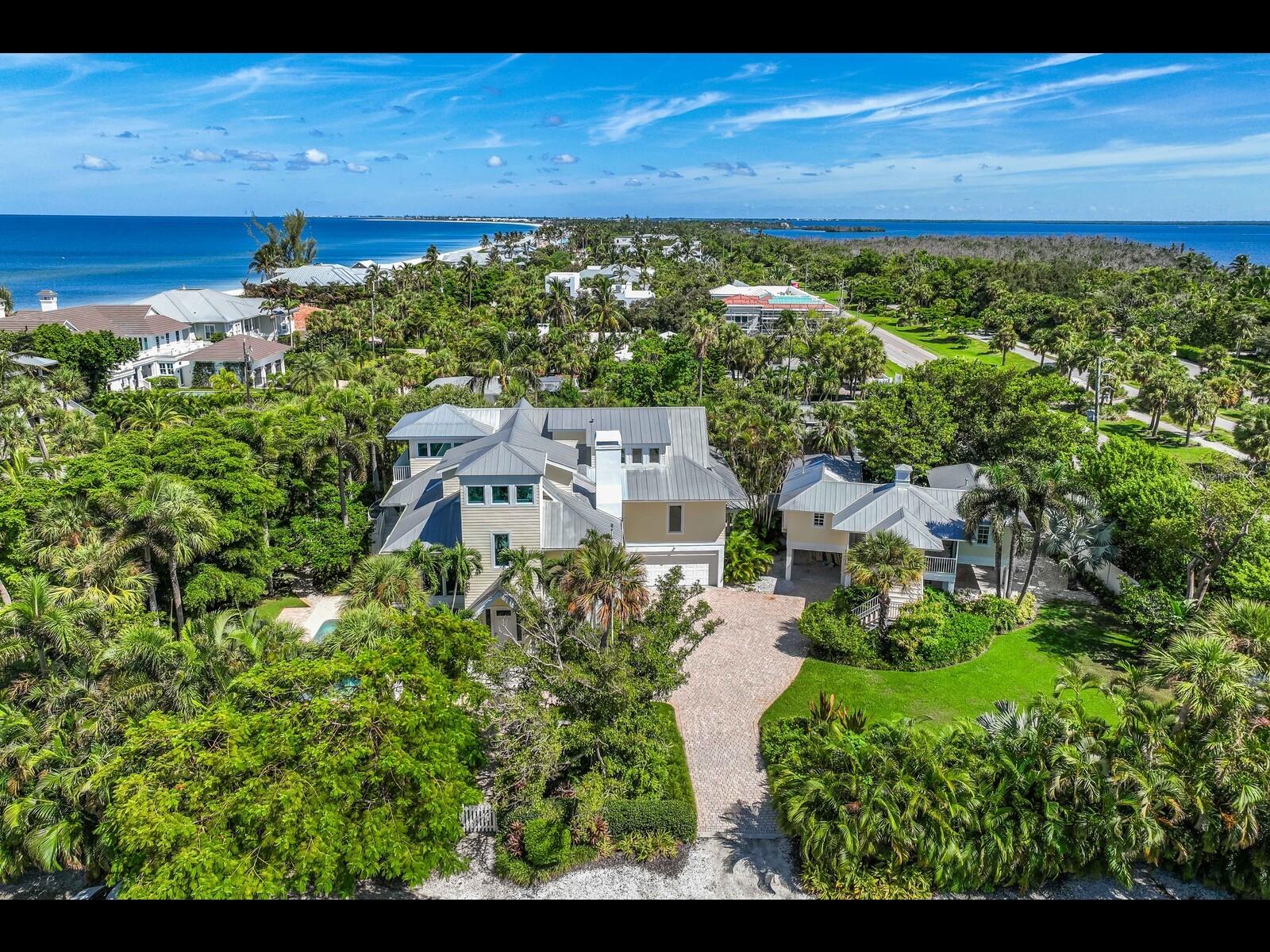 Welcome to 2021 20th Street, Boca Grande, FL! A Family Compound close to the Village on a Private Street with deeded Beach access! Nestled on over half an acre on a Private street in the heart of Boca Grande, 2021 20th Street offers the perfect setting for family gatherings where memories are made. This one of a kind property boasts a large 5 bedroom main home and a charming 3 bedroom guest cottage. The tropical setting provides an ideal backdrop for family gatherings, vacations, and creating cherished moments for generations to come. The spacious main home features an open and airy floor plan with high ceilings, a European designed kitchen,large windows, and lots natural light, offering a seamless flow between indoor and outdoor living. Whether you’re hosting family dinners, relaxing by the pool, or gathering for sunset cocktails on the patio, the home's inviting atmosphere fosters connection and togetherness. Surrounded by tropical landscaping, the property ensures privacy while offering plenty of room for outdoor activities and relaxation. For guests or extended family, the delightful 3-bedroom guest cottage provides a perfect retreat with its own kitchen, living area, and comfortable, coastal-inspired design. This separate dwelling allows for privacy and comfort, while keeping everyone close together on the same property. The cottage is also perfect for use as a rental for those owners desiring income to offset the expenses of Island home ownership. One of the standout features of this compound is its deeded beach access, granting direct entry to Boca Grande's beaches. Imagine waking up to the sound of waves, walking down to the beach with loved ones, or enjoying a sunset stroll along the shore—this property gives you the luxury of beach living just steps from your door. The expansive lot provides ample space for family activities, outdoor games, or simply enjoying the tropical surroundings. Whether you're hosting a holiday gathering, a summer barbecue, or a quiet evening with family, this home is designed for lasting memories. With its prime location in Boca Grande, this property offers the perfect balance of seclusion and convenience, just a short distance from the island's charming shops, restaurants, community center, and bike path.
