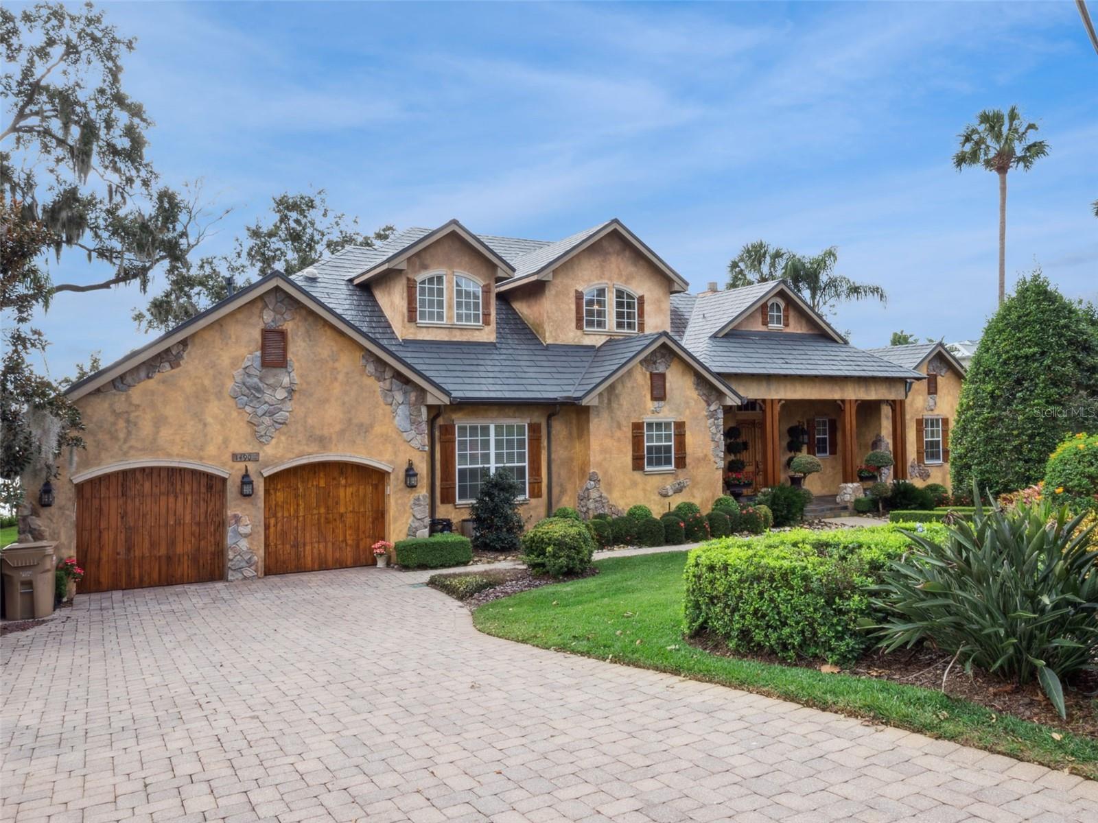 Timeless Lakefront Elegance in the Heart of Mount Dora
Nestled in the coveted covered Chautauqua Park district, this extraordinary lakefront residence captures the charm and tranquility that make Mount Dora so beloved. Showcasing exceptional craftsmanship and thoughtful design, the home offers direct access to the Harris Chain of Lakes and approximately 120 feet of pristine Lake Dora frontage.
Set on an expansive 0.37-acre homesite, the property invites you to embrace the best of Florida’s waterfront lifestyle. Inside, nearly 4,000 square feet of beautifully designed living space features 4 spacious bedrooms and 4.5 baths, filled with natural light and crafted for both comfort and elegance. Multiple covered, screened, and enclosed porches create seamless indoor-outdoor living—perfect for morning coffee overlooking the water or enjoying vibrant sunset views across the lake.
Boating enthusiasts will appreciate the covered boat lift and boathouse, providing effortless access to the scenic Harris Chain of Lakes for days spent exploring, fishing, or entertaining on the water.
The home’s beautifully landscaped grounds enhance both privacy and curb appeal, while the attached garage, paved streets with sidewalks, irrigation system, and exterior lighting add everyday convenience and refinement.
Ideally located just moments from historic downtown Mount Dora, you’ll enjoy boutique shopping, acclaimed dining, art festivals, and year-round cultural events—all while returning home to the serenity of premier lakefront living.
This remarkable property offers the rare opportunity to experience timeless waterfront elegance in one of Central Florida’s most cherished communities.