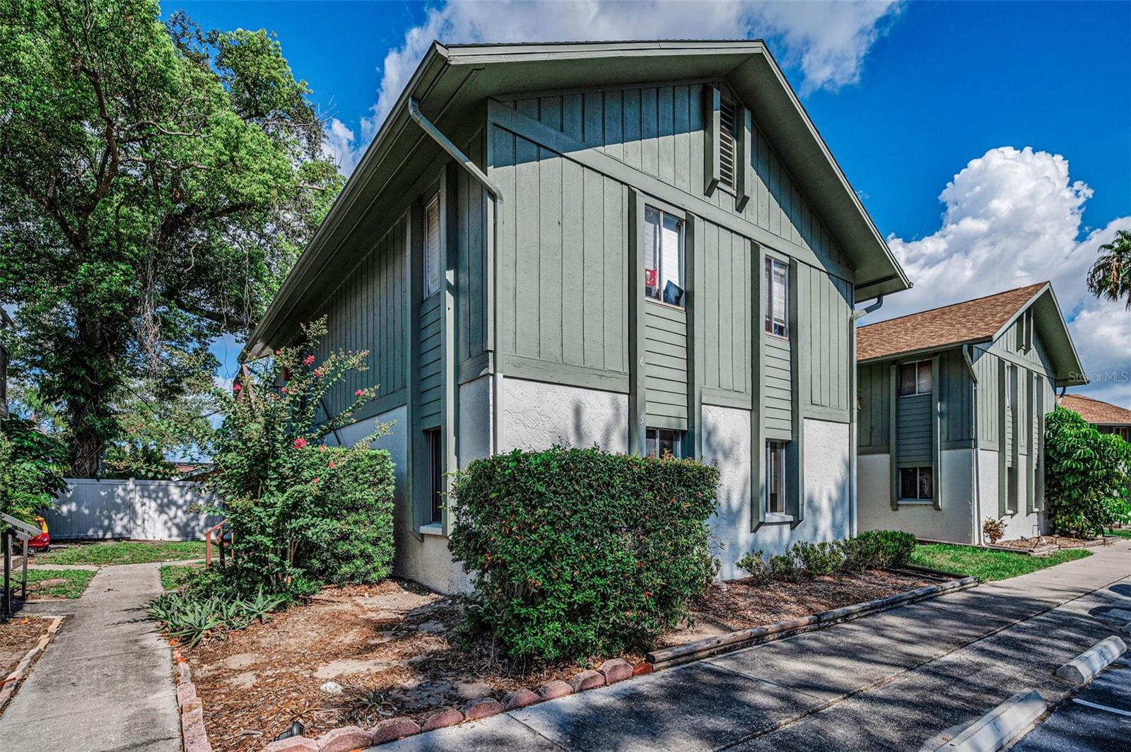 Virtually Staged. Lovely First-Floor Condo in a Prime Clearwater/ Dunedin Location. This nicely maintained first-floor condo offers 2 spacious bedrooms, 2 full bathrooms, a dining area, and a comfortable family room. French doors open to an enclosed patio featuring an exterior door for convenient access to the outdoors.  The primary suite includes a private bathroom with a walk-in shower and a large walk-in closet. The second bedroom is generously sized and located next to the guest bathroom, which features a tub/shower combination. Bedroom dimensions are approximately 12' x 14' and 10' x 12', and both rooms include ceiling fans.  Additional features include a full-size indoor washer and dryer, a 10' x 10' dining area, abundant closet space, neutral décor throughout, and easy-care tile flooring—no carpet anywhere. Built with durable block construction and situated in an X flood zone, this home also offers outdoor water spigots and a small front courtyard area.
Assigned parking is conveniently located directly in front of the unit, with handicap parking nearby for added accessibility.
Residents enjoy a community pool and an unbeatable central location just minutes from charming downtown Dunedin, Honeymoon Island, shopping, dining, and everyday conveniences.  This move-in-ready condo combines comfort, convenience, and a fantastic location—perfect for year-round living or a seasonal retreat.
