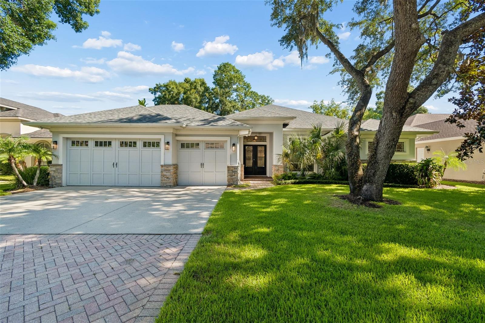 Welcome to Carroll Landing, an exclusive gated community tucked away in one of Tampa's most convenient and desirable locations. Situated near Lake Carroll, this beautifully maintained 4-bedroom, 3-bathroom. 3-car garage home offers over 3,000 square feet of thoughtfully designed living space, combining privacy, comfort, and accessibility in the heart of the city.

Step inside to discover soaring ceilings, elegant architectural details, crown molding, wood flooring, and a spacious split-bedroom floor plan designed for both everyday living and entertaining. The gourmet kitchen serves as the centerpiece of the home, featuring a large island, granite countertops, abundant cabinetry, a walk-in pantry, and updated stainless steel appliances, all seamlessly connected to the surrounding living and dining spaces.

The spacious primary suite offers a true retreat with tray ceilings, dual custom walk-in closets, and a luxurious ensuite bath complete with dual vanities, a soaking tub, and an oversized walk-in shower. Two secondary bedrooms share a convenient Jack-and-Jill bathroom. At the same time, the private study, with built-in bookcases and French doors leading to a charming courtyard, can easily function as a fourth bedroom, home office, or flex space.

Outside, enjoy Florida living year-round from the screened lanai overlooking a fully fenced backyard with mature landscaping, irrigation, and plenty of room to design the pool of your dreams. Major updates include a new roof installed in 2023, providing peace of mind for years to come.

What truly sets this property apart is its exceptional location. Residents enjoy quick access to Lake Carroll, the renowned Babe Zaharias Golf Course, and miles of nearby parks, walking trails, and recreational opportunities. Just minutes away are Carrollwood's popular restaurants, coffee shops, boutique shopping, and everyday conveniences. The home is also ideally positioned near USF, AdventHealth, Moffitt Cancer Center, Downtown Tampa, Hyde Park, Tampa International Airport, and major highways, making commuting throughout the Tampa Bay area effortless.

Opportunities to own in Carroll Landing are rare. Experience the perfect blend of gated privacy, spacious living, and an unbeatable Tampa location.