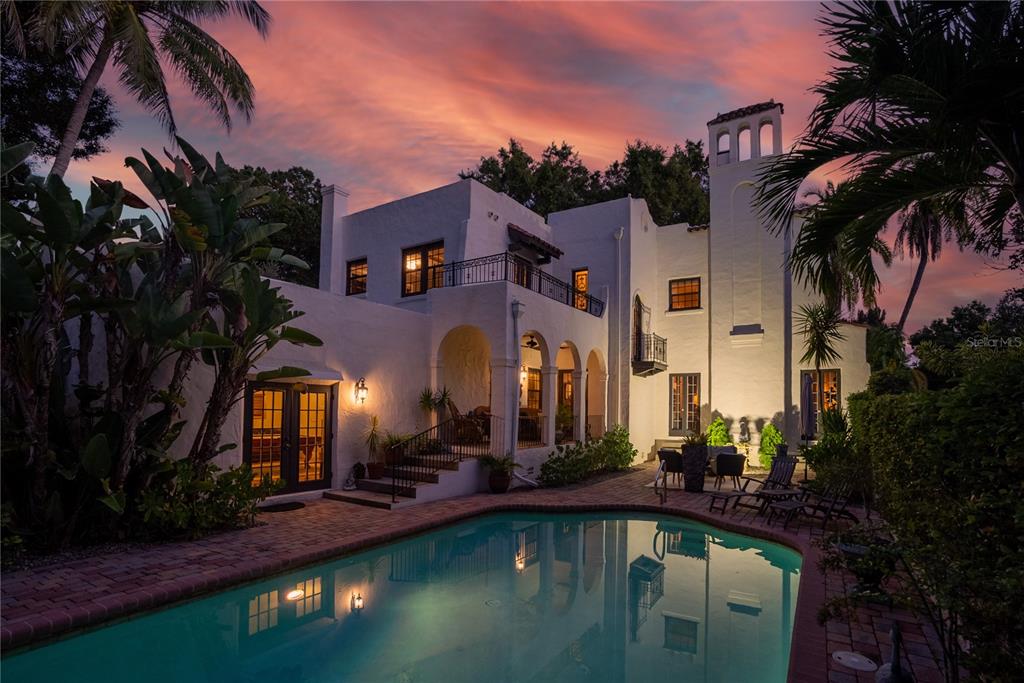 This grand estate, dubbed ’The Spanish Castle’ by acclaimed builder Samuel Schooley in 1920, is located on nearly a full acre in Old Pasadena.  Old world walls, covered in creeping fig, encompass the stately gardens, pool and fountain courtyards, an alfresco dining area, 3 car garage, and gated parking, providing unabridged privacy. At the center of the estate is a historic 5,374 sf, 4 bedroom, 4 bath home where every detail has been meticulously maintained and upgraded to suit modern life.  Upon entering the foyer, you’re welcomed with natural light flowing abundantly throughout the home.  Timeless architectural details have been thoughtfully woven together with all of the modern-day amenities expected in a luxury home. Along with high beamed ceilings, arched windows and doors, crown moldings, and exceptional oak floors are a few little surprises; a vintage telephone room, an apothecary cabinet, and stained-glass accents which add to the charm this home exudes.  Amongst the many modern upgrades are new AC systems, natural gas appliances, and custom Norman solar shades (partially motorized) installed throughout to improve energy efficiency. Entertain with ease from a formal living room with gas fireplace.  Move into to the discerning tasting room with extensive wine storage, which flanks the formal dining room with original Cuban tile floors, chandeliers, and French doors.  End your evening in the expansive billiards room with an antique wet bar, wood fireplace, and Saltillo tile floors. The newly remodeled kitchen, a masterpiece of design, offers both function and architectural consistency.  The statement piece, an 1880’s draper’s table from a silk factory in Lyon France, serves as the island.  The Viking appliance suite including a 48” range with grill, built-in refrigerator, and separate cold beverage storage.  Custom cabinetry was fabricated with furniture trim finishes and is accented by Danby Marble countertops, hand-painted terracotta backsplash, and solid, unlacquered brass fixtures.  It truly is a chef’s dream kitchen!  The remarkable checkered floor is hand-quarried marble and limestone from France and leads to a landing area presenting ancillary cabinetry and a coffee bar.  The expansive master suite comprises an entire wing and offers a private tea garden, wood-burning fireplace, his and her custom closets, and a large en suite bath. There is also access to a private balcony in the fountain courtyard. Located upstairs is the original master bedroom with wood-burning fireplace, 2 additional bedrooms, and 2 full baths.  It’s the perfect split floor plan for families and also great guest accommodations. There are so many additional unique details to share, which only a private tour of this majestic home can reveal.  Schedule your appointment today.