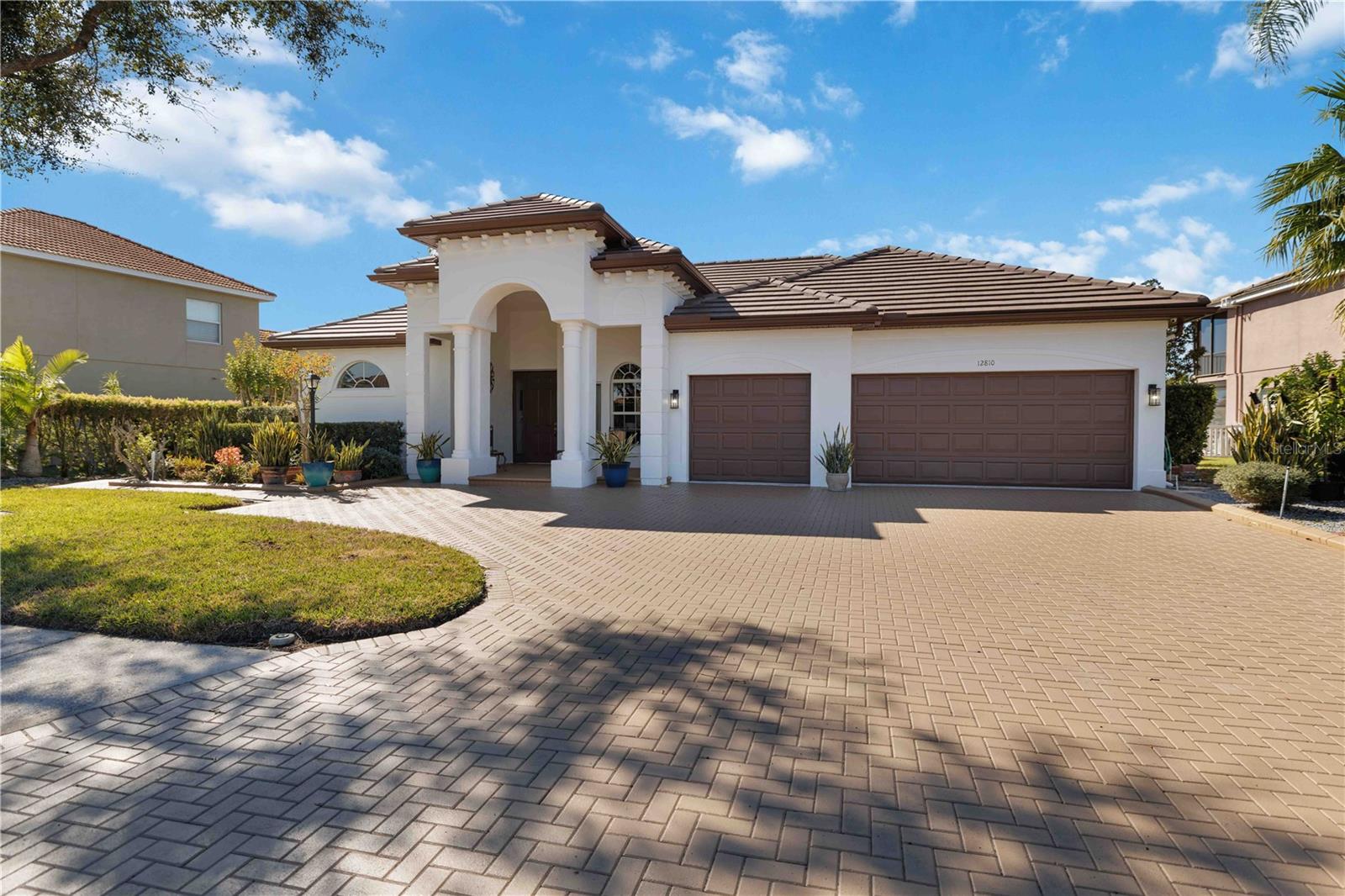 Experience the best of Florida lifestyle living in the gated community of Greyhawk Landing with this spacious executive pool home designed for multigenerational living, entertaining, and everyday comfort. NEW ROOF, NEW POOL SCREEN, NEW EXTERIOR PAINT, NEW WATER SOFTENER, SOLAR PANELS, GUTTERS, and a fully fenced tropical backyard, this move-in-ready residence offers exceptional value, energy efficiency, and peace of mind. The expansive 4-bedroom, 3.5-bath floor plan provides room for everyone with timeless architectural details including tray and vaulted ceilings, crown molding, graceful archways, and elegant finishes throughout. The private primary suite serves as a relaxing retreat with a spa-inspired bath featuring dual vanities, soaking tub, oversized walk-in shower, and linen storage, while three additional bedrooms are thoughtfully positioned with two full baths for family and guests. Upstairs, a large bonus room with half bath and new mini bar creates endless flexibility for a media room, guest suite, home office, fitness space, or game room. Triple pocket sliders seamlessly blend indoor and outdoor living, opening to an oversized heated lap pool surrounded by lush tropical landscaping, paver decking, and a screened lanai designed for year-round enjoyment and entertaining. Located in one of East Manatee County’s most sought-after gated communities. Greyhawk Landing offers resort-style amenities with remarkably low HOA fees of approximately $75 per year, including two community clubhouses, lagoon-style pools with waterslide, fitness center, tennis and pickleball courts, basketball courts, soccer and baseball fields, fishing pier, miles of nature trails, scenic lakes, and abundant wildlife. Ideally positioned near Lakewood Ranch, Sarasota, Gulf Coast beaches, top-rated schools, golf, dining, shopping, boating, and medical facilities, this exceptional property delivers the perfect blend of luxury, flexibility, privacy, and the true Florida lifestyle.