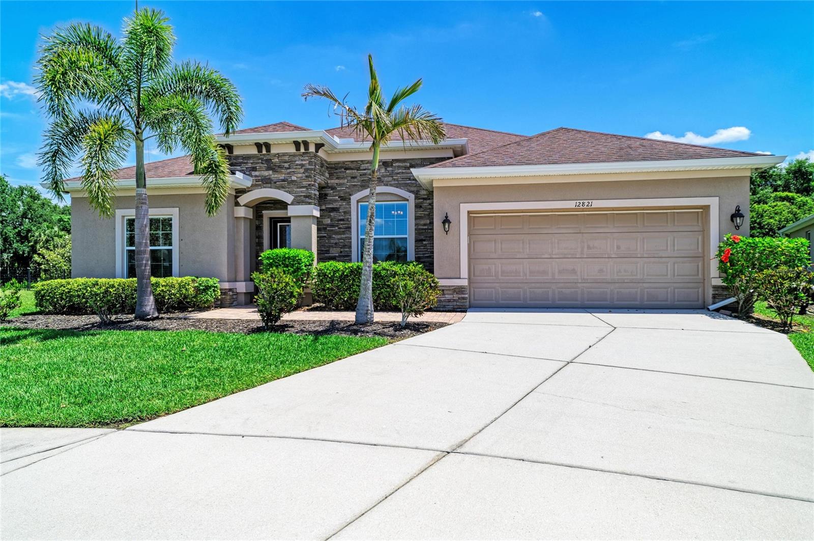 Positioned within the gates of Greyhawk Landing, this Ryland Homes built Inverness floor plan offers a spacious and flexible layout designed for everyday living and long-term comfort. With 5 bedrooms, 3.5 bathrooms, a dedicated den or study, and approximately 2,861 square feet, the home provides the kind of separation and functionality that works well for multi-generational living or anyone needing defined space to spread out. At the center of the home, the kitchen is designed to bring people together, featuring custom cabinetry, a large stone island, and stainless steel appliances including a gas range. It opens naturally to the main living areas, creating an easy flow for both daily routines and gatherings. Tile flooring runs throughout the main living spaces, with wood-look tile extending into the living room and all bedrooms, offering a consistent and low-maintenance interior. The primary suite is privately positioned at the rear of the home, complete with a walk-in closet, dual vanities, soaking tub, and walk-in shower. Sliding glass doors lead directly to the extended stone lanai, creating a seamless transition to outdoor living. The backyard is fully fenced and offers generous space on both sides of the home, providing flexibility for pets and play. Major systems have been addressed with the HVAC replaced in 2021, adding peace of mind for the next owner. Additional features include a 3-car tandem garage with electric vehicle charging capability, a dedicated laundry room with utility sink, and ample storage throughout. Greyhawk Landing is a guard-gated community known for its mature landscaping and established feel, offering two community pools, a fitness center, tennis, pickleball and basketball courts, fishing pier, and miles of walking trails. Conveniently located with access to top-rated schools, shopping, dining, and the Gulf Coast beaches, this home presents a solid opportunity within one of the area’s most established neighborhoods.