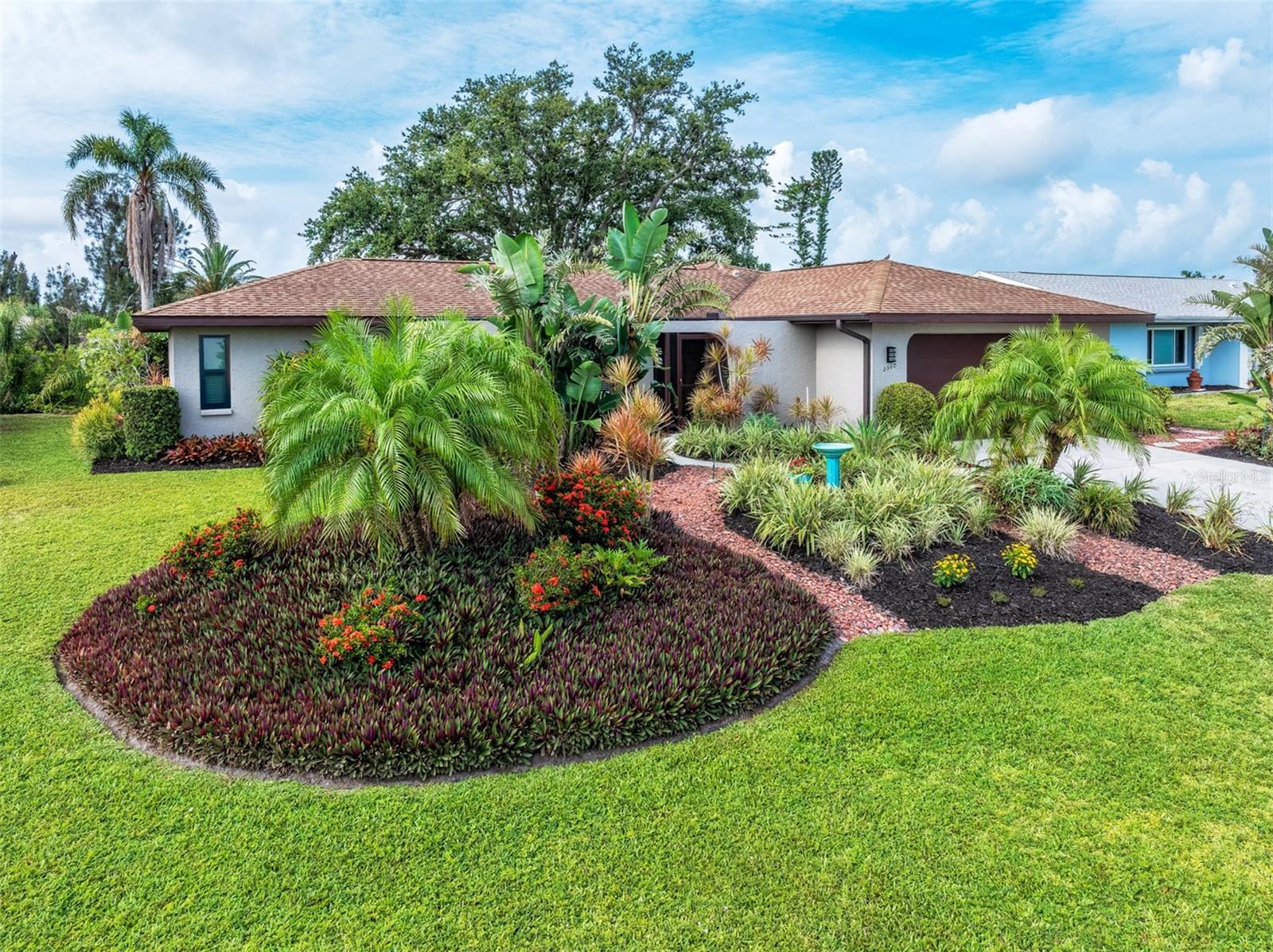 BRAND NEW IMPACT WINDOWS – FRESH EXTERIOR PAINT. Welcome to this beautifully updated waterfront retreat in the highly sought-after Venice Gardens neighborhood. Tucked away on a quiet cul-de-sac bordering a peaceful bird sanctuary, this exceptional home offers stunning water views and complete privacy with NO HOA and NO CDD . Lush tropical landscaping enhances the remarkable curb appeal, highlighted by a welcoming front patio excellent for morning coffee and a covered, screened-in entry. This elegant, open floor plan features 3 bedrooms and 2 bathrooms in a split layout. High-grade porcelain tiles run through every room except the bedrooms, which feature comfortable carpet. The interior is accented with high-quality ceiling fans with remotes and stylish mid-century modern light fixtures. The newly updated kitchen beautifully blends retro charm with modern functionality, showcasing a unique tile backsplash, durable quartz countertops, sleek stainless-steel appliances, a large granite Kraus sink, and a garbage disposal. The breakfast area leads to a cozy sitting room, while the formal living and dining areas both feature sliding doors that open to large enclosed sunroom with exquisite water views. Both bathrooms are upgraded with modern fixtures, custom medicine cabinets, and high-end lighting to create a luxurious and functional space, plus the guest bathroom includes a new toilet. Additional features include an oversized 2-car garage with side entrance and 2015 roof equipped with new gutters, downspouts, and leaf guards. The backyard is a true gem, featuring a beautifully paved, south-facing patio where you can relax and soak in the Florida sunshine. This serene freshwater retreat perfectly accommodates an elegant lake lifestyle, welcoming electric-motor boating, kayaking, canoeing, and paddle craft right from your backyard. Prime Venice location nearby the Jacaranda West Golf Course and just minutes from Historic Downtown Venice with its many shops, restaurants, medical facilities, local schools, year-round events, and beautiful Gulf beaches. An optional HOA available to access community pool and community clubhouse.  Don't miss this incredible opportunity to make this true Florida dream home your own today!
