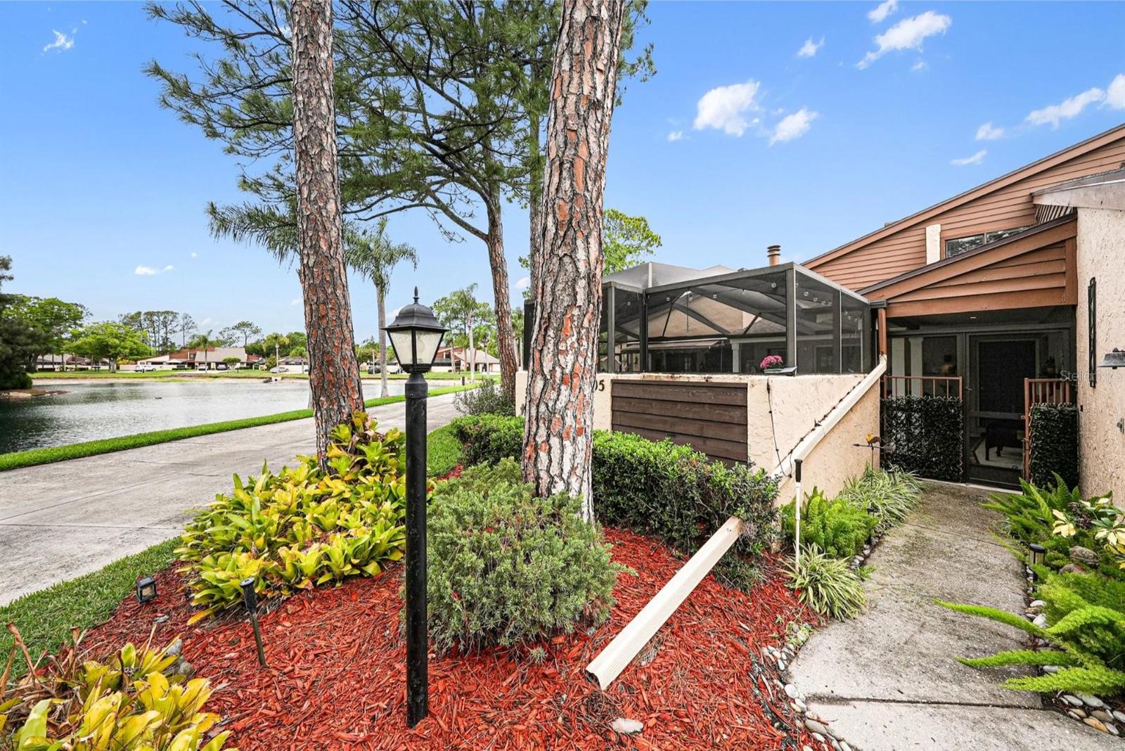 CREDIT FROM SELLER TO BUYER OF $5,000 AT CLOSING! The seller is offering this generous $5,000 credit to be used for anything the buyer might want to fix, upgrade, or customize upon moving in, or it can be applied directly toward buying down your interest rate or covering closing costs. Welcome to your private oasis at 4805 Umber Ct, Tampa, FL 33624, a stunningly remodeled villa for sale in the highly sought-after, gated community of Heatherwood Village. Positioned on one of the premier waterfront lots in the subdivision, this move-in-ready townhouse offers a rare combination of privacy and serenity with a sweeping, picturesque pond view that serves as the perfect backdrop for daily Florida living.

This turnkey luxury home has been meticulously transformed with over $40,000 in recent upgrades and capital improvements. Upon arrival, you are greeted by an oversized, fully enclosed front courtyard featuring newly poured concrete and dramatic raised ceilings—the ultimate secluded sanctuary for al fresco dining, grilling, or morning coffee. Step inside to a bright, open-concept floor plan that shines with towering vaulted ceilings, updated lighting, and durable high-end laminate wood flooring throughout. The heart of the home is a gourmet designer kitchen, boasting premium granite countertops, a massive single-level kitchen island perfect for entertaining, stainless steel appliances, and a built-in wine refrigerator. The spacious living room invites you to cozy up by the wood-burning fireplace featuring a custom accent mantel piece. For maximum living flexibility, the property boasts a rare dual primary suite layout—featuring two master bedrooms (one on the first floor and one on the second level)—making it ideal for multi-generational living, roommates, or a premium work-from-home office space.

Enjoy the ultimate maintenance-free lifestyle in this secure, gated neighborhood where the low HOA dues conveniently include water, sewer, trash, and ground maintenance. Residents also enjoy access to premium community amenities, including a sparkling community pool, clubhouse, and playground. Perfectly located in the heart of the Carrollwood/Northdale area, you are just minutes away from Tampa's premier shopping, fine dining, and major highways, offering an effortless commute via the Veterans Expressway to downtown Tampa and the Tampa International Airport. Real estate of this caliber on a premier pond-view lot rarely becomes available in Heatherwood Village—with a flexible credit from seller to buyer ready to address any minor fixes or personal touches you desire, this modern Tampa gem won't last long. Schedule your private tour today before it is sold!
