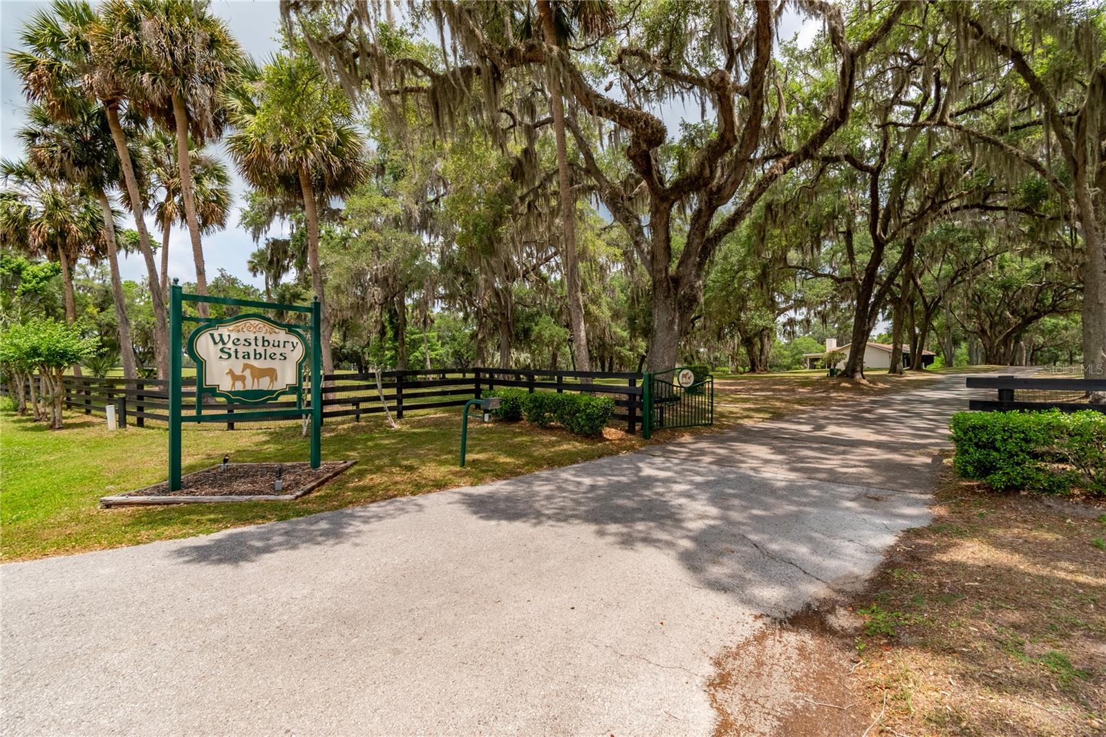 Under contract-accepting backup offers. Set on 128+ acres of gently rolling hills, this impeccably maintained horse farm offers an exceptional blend of functionality, versatility, and Central Florida charm. Every detail of this farm shows the passion the seller had for their horses and the land they lived on. Fenced and gated, the property is dotted by magnificent trees for gentle shade and connected by asphalt driveways throughout for added day-to-day ease. Every detail has been thoughtfully designed to support a premier horse operation while providing comfortable residential and business accommodations. Three barns are established on the property, providing a combined 50+ stalls and features that include center aisles, tack rooms, wash racks, feed rooms, fly spray systems, barn offices, barn apartments, and additional support spaces depending on the barn. Several paddocks and pastures are in place, as well as round pens, eurocizers, waterers in every paddock, and feeding stations. Two picturesque ponds are also on property, complete with fountain features to add to the property’s stunning landscape. Multiple residences, apartments, and office spaces create great flexibility for owners, guests, staff, or operational use. The main residence provides comfortable living spaces with a private pool, while additional homes and accommodations provide ample opportunity for passive income from seasonal or long-term rentals. A huge equipment building allows for storage for large farm machinery, trailers, and other equipment, complemented by an on-site fuel station for added convenience and efficiency. Beautifully maintained from every angle, this extraordinary property combines scenic surroundings with the infrastructure and amenities needed for a first-class facility. Several competition and show venues are located within 25 minutes of the property, including the World Equestrian Center (WEC), HITS, Sweet Dixie South, and Majestic Oaks. This area is convenient to a variety of tack and feed retailers, equine service providers, and world-class veterinary care, making it an ideal opportunity for those looking to bring their operation to the next level in the Horse Capital of the World®.