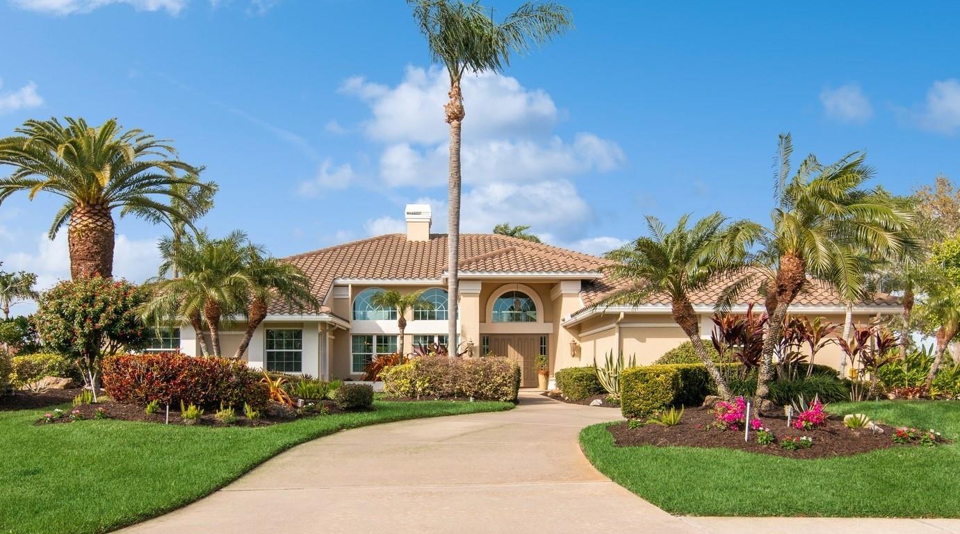 Nestled within the TPC Prestancia Golf and Social Club, this immaculate property offers unparalleled luxury living with 3 bedrooms, an office and oversized living areas. Situated on an expansive lot, this residence provides an exceptional quality of life in a serene setting with breathtaking views. As you enter through the grand foyer, you’re greeted by a spacious floor plan boasting high ceilings and abundant natural light as each room is open to the outdoors. Exquisite touch of architectural details, including a stunning curved wall adds a touch of elegance to the living room and dining room. A cozy gas fireplace and a wet bar conveniently separate the living and dining rooms, creating an ideal space for entertaining guests. The gourmet kitchen, open to the spacious family room, is thoughtfully designed with panoramic views of two tranquil ponds and the greenery of the golf course, creating a picturesque backdrop to inspire your culinary creativity! The living areas seamlessly flow to the outdoor oasis, where a newer resort-style pool and spa await. Outdoor living here is a dream with different areas to welcome your friends, to enjoy an Al Fresco dinner or simply to relax. An outdoor kitchen and pool bath complete this oasis, with gorgeous travertine on the floor, enclosed by a high wind-resistant pool cage, ensuring durability and safety. The master suite is a serene retreat, offering a spacious bedroom, large walk-in closets and an additional area perfect for reading, meditation or for your personal gym. 
The office with built-in bookshelves sits just on the side of the Master bedroom as well as the guest powder room. The two guests’ bedrooms and bathroom are located on the other side of the house for privacy. An oversized three-car garage with plenty of storage completes the property. With costal windows and sliding doors, only seven years old tile roof, 2 AC units (2020,2023) and two water heaters (2018, 2023), this home gives you the peace of mind to live your life fully. TPC Prestancia offers several membership options, including access to two 18 golf courses and a restaurant, although they are not mandatory for residents. Conveniently located just minutes away from downtown Sarasota and downtown Venice, with proximity to Siesta Key, renowned for its beautiful beaches, and shopping areas, this home offers the perfect blend of luxury and convenience. Schedule your private showing today and discover this elegant property on one of the best addresses of Palmer Ranch, Sarasota.