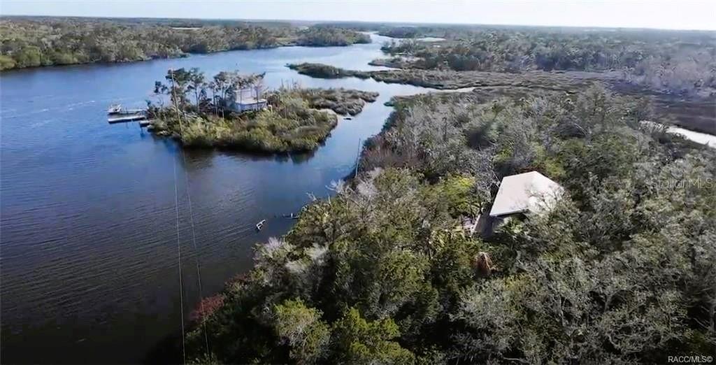 Homosassa Island Living on the Homosassa River – Your Escape to the Gulf. Live where others vacation! This rare island retreat on the Homosassa River, perfectly positioned on the way to the Gulf of Mexico, offers approximately 2.5 acres of natural waterfront paradise—complete with electric already in place. This charming 2-bedroom, 1-bath home features cathedral ceilings and an open floor plan that maximizes natural light and showcases those unforgettable water views. The wraparound island bar connects beautifully to the kitchen, making it the perfect space for entertaining, relaxing, and soaking in the island lifestyle. Built for both comfort and peace of mind, the home includes a metal roof, hurricane shutters, and a storage shed for all your gear. Whether you’re looking for a weekend escape, a one-of-a-kind vacation rental, or your own slice of Old Florida, this is a property that truly stands apart.