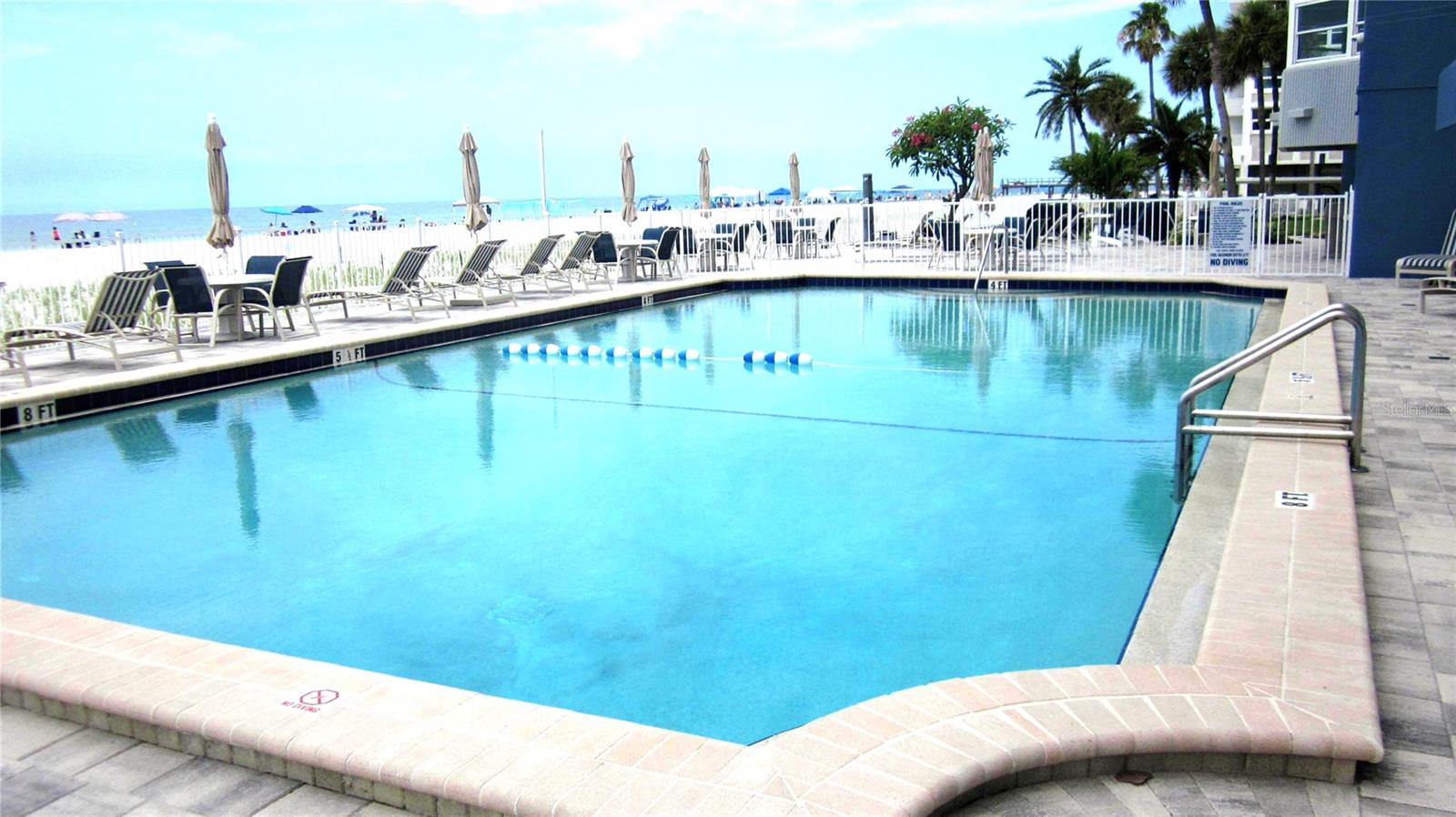 The beach isn’t just a place—it’s a lifestyle. This beautifully updated 2 bedroom, 2 bath coastal retreat is located on white sands of North Redington Beach, perched on the third floor of Tower Isle provides for quiet, relaxed coastal living. Step inside to 1,070 sq. ft. of thoughtfully designed space, plus an additional 180 sq. ft. enclosed porch that expands the great room—complete with custom Shaker built ins for extra storage. The interior is finished in soft coastal grays and blues, with plank look tile, Craftsman doors, Key West style plantation shutters, and coastal ceiling fans throughout. Sit by the pool or walk in the sand for a front row seat on the newly renourished beach and the unforgettable Gulf sunsets. The primary suite features an en suite bath and a walk in California closet, while the guest bedroom enjoys its own separate bath. The well appointed kitchen includes white Shaker cabinetry, granite countertops, a glass tile backsplash, stainless/black appliances with a double oven, designer lighting, and a high bar perfect for chatting with friends while prepping drinks and appetizers. Additional conveniences include an in unit washer/dryer, impact windows, an assigned covered parking space, ample guest parking, and a spacious storage locker for beach toys—and then some. The reasonable monthly maintenance fee covers a lot, making this an easy, low maintenance choice for a full time residence, vacation getaway, or investment property. Tower Isle’s well managed association is already restoring the common areas to look better than ever. Trade your leaf blower for flip flops and come experience this move in ready slice of coastal living. See it for yourself—your beach lifestyle is waiting.