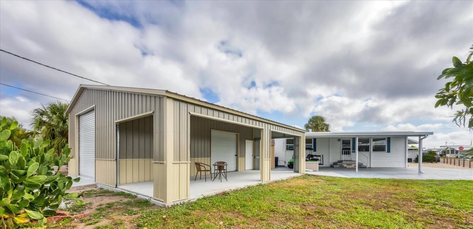 IMPECCABLE STORAGE and FUNCTIONALITY! A gorgeous Coastal Farmhouse renovation, 2 Bedroom, 2 Bathroom Double Wide Mobile Home, AND a brand NEW 20'x30'x11' detached Garage with attached 12'x30' Carport that offers not just parking but a wealth of functional space, perfect for hobbies, equipment storage, or a home gym. Situated on a fantastic double corner lot (almost 6000 sq ft) in the highly desired, active 55+ Trailer Estates community, this property is just one block from the Trailer Estates Marina. Custom Kitchen cabinets, new stainless steel appliances, quartz countertops and ceramic tile backsplash. Custom Bathroom cabinets, solid surface countertops with integrated bowls. New washer and dryer. Luxury vinyl floors throughout, no transitions. All windows and doors replaced. Upgraded insulation. Roof 2019; new AC motor 2024. WDO treated 2025. Paver patio for grilling and gathering, and a separate 8x10 Shed complete this piece of Paradise. The new Garage building has just been completed and electric and water is available and ready for installation, if needed. Bring your classic car, bring your boat, bring your project...the only thing missing is your Big Boy Toys! You own the land. No lot rent, Park Fees are included into annual real estate taxes. Boaters have direct access to Sarasota Bay from the Marina. Trailer Estates community offers so many options for a great day! Enjoy the large, heated community pool, hot tub, gym and wood shop. The community buzzes with pickleball, shuffleboard, kayaking, horseshoes, bocce, dancing and more. A US Post Office on site. 10 minutes to the SRQ Airport. Convenient to shopping, restaurants, the Arts and everything in Bradenton/Sarasota. Sold unfurnished. Bring offers!