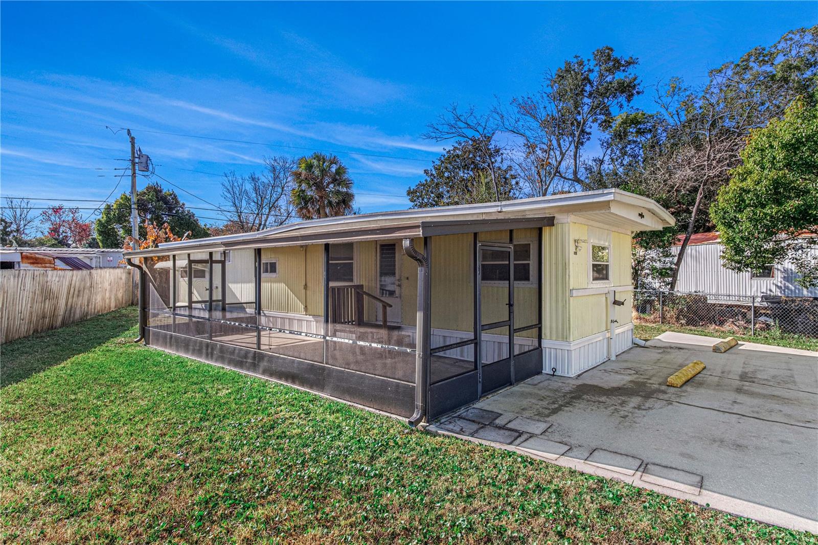 No HOA! No Lot Rent! You Own the Land! This move-in ready and meticulously maintained mobile home offers an affordable opportunity to enjoy Florida living on your own fully fenced lot. Inside, you'll find a bright, refreshed interior featuring a white kitchen, fresh paint, and new flooring throughout. The home offers 2 bedrooms and 1.5 baths, including a convenient half-bath in the front bedroom. Relax or entertain on the expansive 41x9 screened porch with plenty of space for outdoor living, hobbies, or additional storage. Additional features include an indoor washer hookup, storage shed with dryer hookup, and private financing available. A clean, well-cared-for home ready for its new owner! Private Financing Available. All information taken from the tax record, and while deemed reliable, cannot be guaranteed.