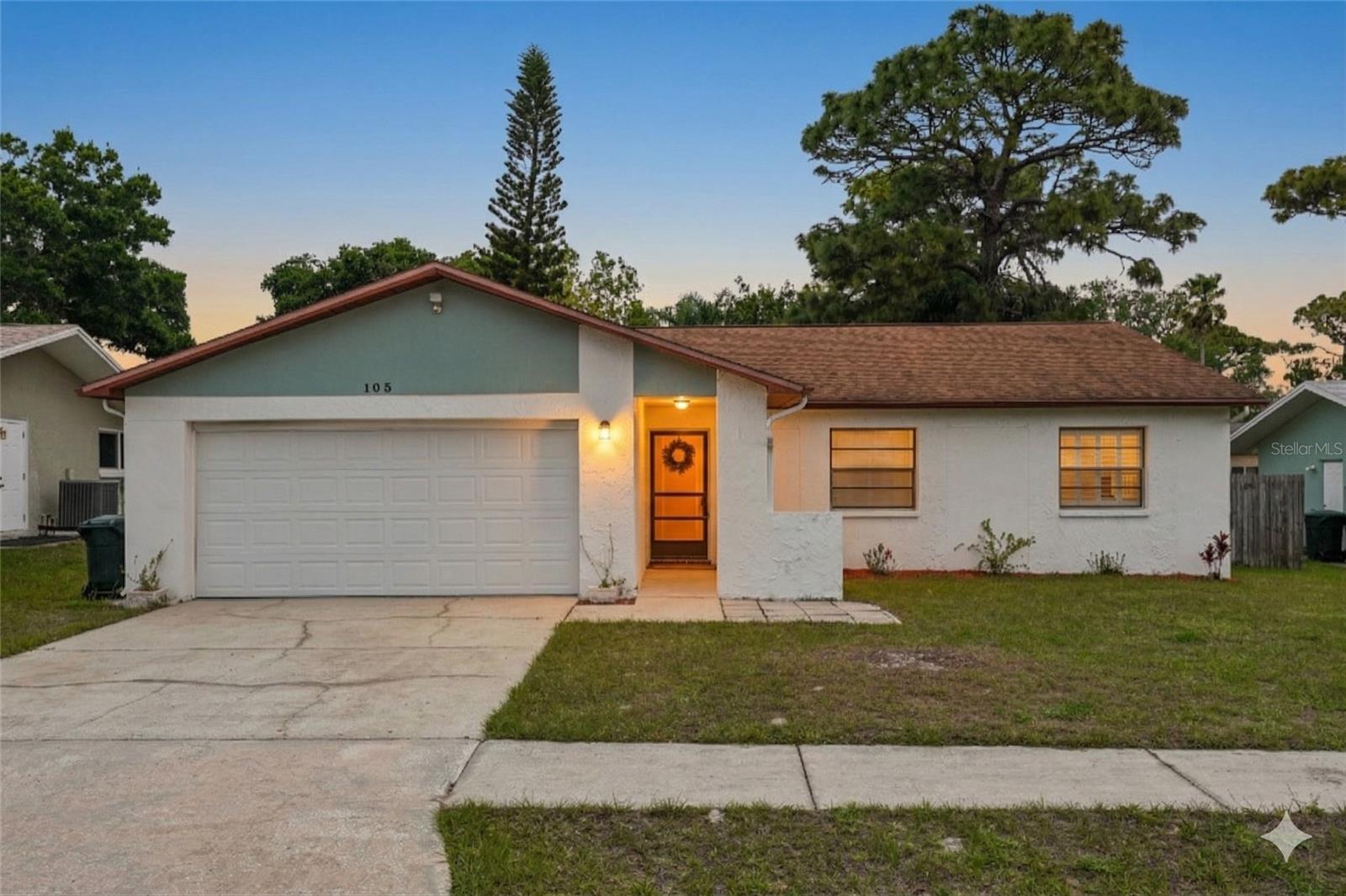 One or more photo(s) has been virtually staged. Welcome home to Safety Harbor! This beautifully maintained 3-bedroom, 2-bathroom block home at 105 Lotus Circle is tucked away on a quiet cul-de-sac, offering a bright, open-concept layout that feels like a breath of fresh air. Freshly painted inside and out, the residence shines with pride of ownership and modern appeal. You’ll love the vaulted ceilings and stylish wood-look flooring that lead you toward a cozy brick fireplace—the perfect centerpiece for relaxing nights in. The heart of the home is the updated kitchen, complete with granite countertops, solid wood cabinets, and a breakfast bar for easy morning coffee. With a smart split-bedroom plan, the primary suite feels like a true retreat, now featuring brand-new laminate flooring that extends through all bedrooms for a clean, carpet-free finish. Step outside to the screened-in back patio and massive fenced yard, a space just waiting for your next weekend BBQ or garden project. Best of all, you’re just minutes from the charm of downtown Safety Harbor and Philippe Park, all while enjoying the peace of mind of a non-flood zone. It’s move-in ready, full of character, and waiting for you to call it home!