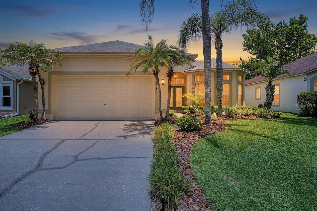 Welcome to 19027 Weatherstone Drive, a beautifully maintained pool home nestled on a premium pond-front homesite in one of New Tampa's most desirable communities. This spacious 3-bedroom, 2-bathroom residence offers an ideal blend of comfort, elegance, and Florida outdoor living. Step inside to soaring ceilings, abundant natural light, and a thoughtfully designed split-bedroom floor plan featuring formal dining space, a generous family room, and a spacious primary suite with a large walk-in closet and private bath. The well-appointed kitchen is the heart of the home, offering granite countertops, ample cabinetry, a center island, and a bright breakfast nook surrounded by picturesque windows overlooking the water. The expansive family room seamlessly connects to the outdoor living area through sliding glass doors, creating the perfect space for entertaining and everyday living. Outside, enjoy your own private oasis featuring a screened-in pool and covered lanai with tranquil pond views, mature tropical landscaping, and breathtaking sunsets. Whether you're relaxing poolside or hosting friends and family, this backyard setting is truly special. Additional highlights include hardwood flooring, crown molding, an oversized 2-car garage, interior laundry room, and a desirable location close to shopping, dining, top-rated schools, parks, golf, and major commuter routes. Residents also enjoy access to community amenities including tennis courts, basketball courts, and playgrounds. Experience the best of Florida living in this exceptional waterfront home. Schedule your private showing today.