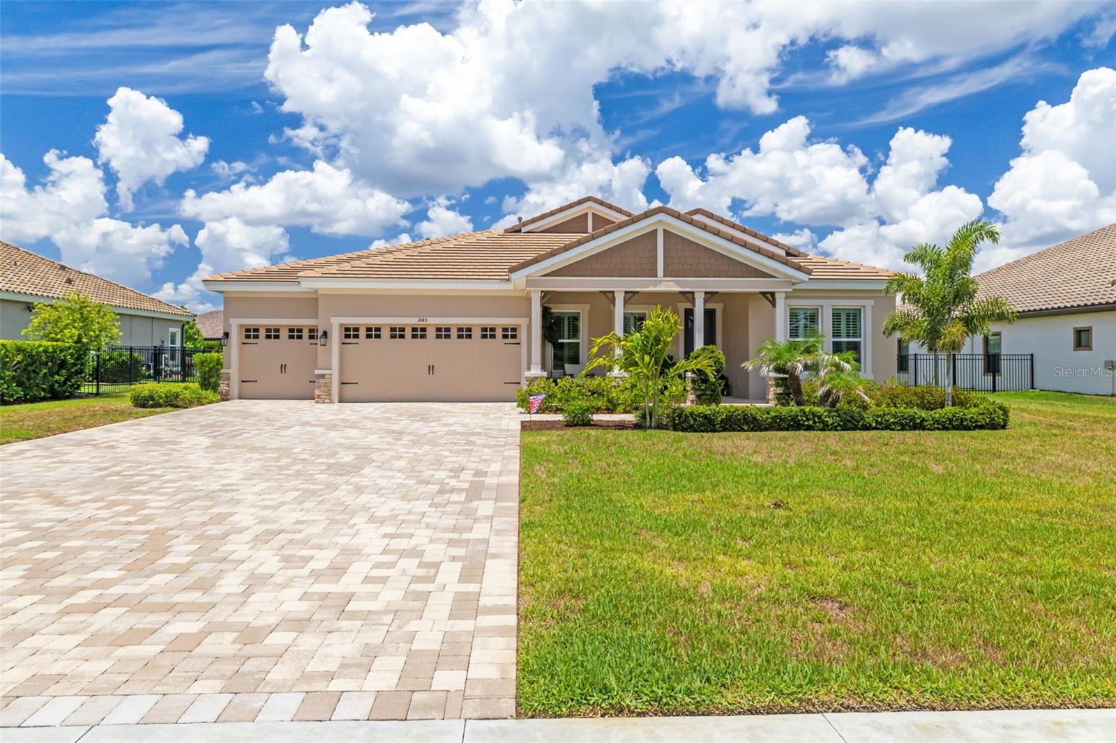 WOW! Built in 2023, Welcome to a truly exceptional luxury residence where timeless craftsmanship meets elevated modern living. Features: 4 bedroom, 3 bath, almost 3,200 sqft of living space, PLUS OFFICE, PLUS SEPARATE DINING/ SITTING ROOM ETC.. PLUS A BONUS ROOM, 3-car garage with a backyard you never want to leave!!! Designed with impeccable attention to detail, this stunning home showcases a premium Craftsman elevation with an expansive front porch that creates an unforgettable first impression. Inside, every space has been thoughtfully upgraded with sophisticated finishes, custom architectural details, and designer touches throughout. The heart of the home is a show-stopping custom kitchen featuring Level 6 quartz countertops, upgraded cabinetry with a fully customized layout, designer backsplash, custom hood, pull-out storage cabinetry, and a premium 36” cooktop appliance package — perfectly curated for both entertaining and everyday luxury. Elegant tray ceilings accent the dining room, foyer, office, and owner’s suite, while wood beam details in the family room, wood plank ceilings, and custom foyer wall treatments add warmth and character throughout the home. The owner’s retreat offers a spa-inspired bath complete with a freestanding soaking tub and upgraded Level 6 & 7 designer tile selections. Additional interior enhancements include upgraded interior doors, plantation shutters, custom dining area cabinetry, laundry room cabinetry, new designer lighting and ceiling fans, upgraded tile flooring throughout the main living areas, and a beautifully designed wine wall with integrated lighting. Seamless indoor-outdoor living is created with dramatic 18-foot sliders opening to an extraordinary backyard oasis. The resort-style outdoor space features a custom pool with extensive Shellstone decking (stays cool under sunlight), lush privacy landscaping, built-in outdoor speakers, and a luxurious pavilion complete with a stone fireplace, TV, and full outdoor kitchen including an additional flat-top grill — the ultimate entertaining destination. Additional premium upgrades include a bonus room addition, craftsman-style front door, water softener pre-plumb, upper garage storage, and built-in audio in both the outdoor living space and owner’s bath. This home is the perfect blend of luxury, comfort, and thoughtful design — offering an elevated lifestyle in every detail. The Community is zoned for TOP RATED SCHOOLS- Newsome High School included. Offering a peaceful, country-like setting with convenient access to I-75, MacDill AFB, and the shopping and dining of Lithia and Brandon, this home delivers the best of luxury living. Why wait to build when the perfect home and the perfect backyard oasis are ready now!! Schedule your showing today.