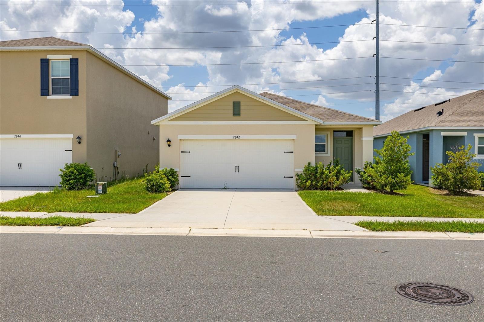 Welcome to **2842 Waterlily Way** in the desirable **Lake Deer Estates** community! Built in 2024, this move-in ready **4-bedroom, 2-bathroom** home offers modern design, an open-concept floor plan, and all the benefits of newer construction without the wait.

Step inside to discover a bright and spacious layout featuring ceramic tile throughout the main living areas, abundant natural light, and a split-bedroom floor plan designed for privacy and functionality. The stylish kitchen is the heart of the home, showcasing stone countertops, a large center island with seating, stainless steel appliances, ample cabinet space, and a generous pantry—perfect for entertaining or everyday living.

The spacious primary suite offers a relaxing retreat with a walk-in closet and private en-suite bath featuring dual vanities and a walk-in shower. Three additional bedrooms provide flexibility for family, guests, or a home office.

Enjoy Florida living year-round from the covered rear lanai overlooking the backyard, with plenty of space to create your own outdoor oasis. The home also includes a two-car garage, energy-efficient construction, and low-maintenance landscaping.

Residents of Lake Deer Estates enjoy fantastic community amenities including a resort-style pool, playground, dog park, sidewalks, and internet included with the HOA. Conveniently located near shopping, dining, schools, and major roadways, this home offers easy access to everything Central Florida has to offer.

Don't miss your opportunity to own this beautifully maintained, nearly new home—schedule your private showing today!